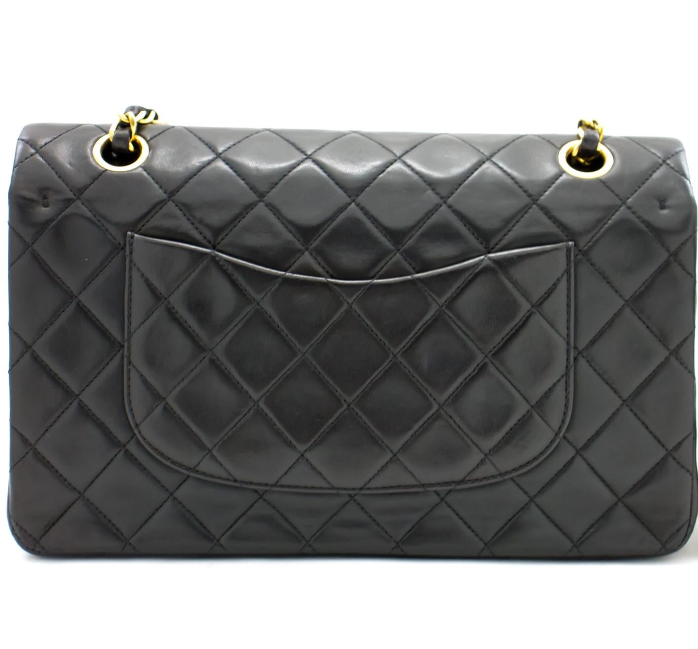 This iconic Chanel 10 inch bag from 1994 - 1996 is crafted from quilted black lambskin and features a double flap. On the front flap there is the classic CC logo twist lock and on the second flap a stud closure with one slip-in pocket. The inside