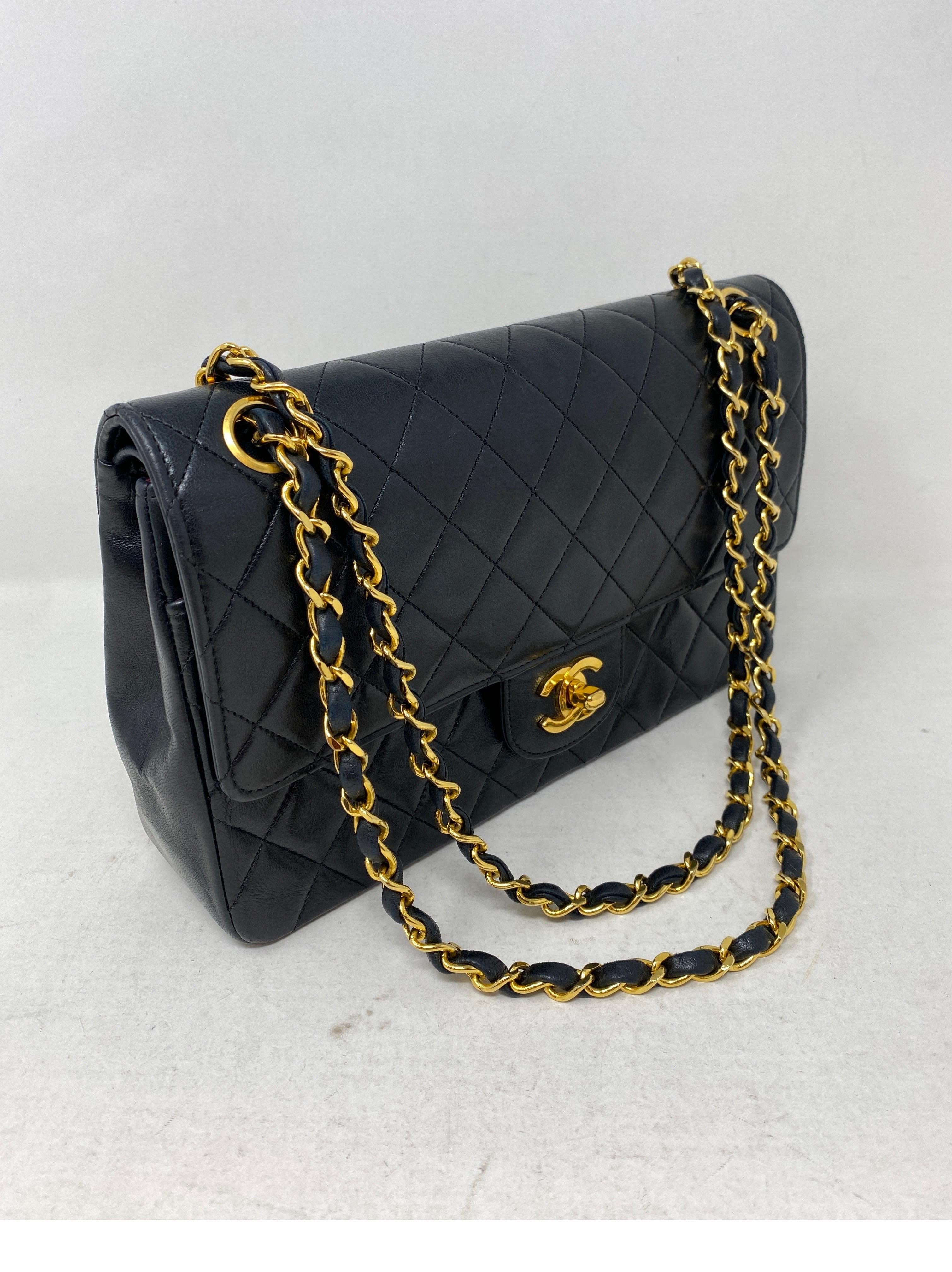 Chanel Medium Double Flap Bag. Black lambskin leather bag. Gold hardware. Vintage Chanel Bag. 24 kt gold plated hardware. Classic bag from Chanel. Side pocket has light wear and rubbing from age. Beautiful bag overall. Classic 10