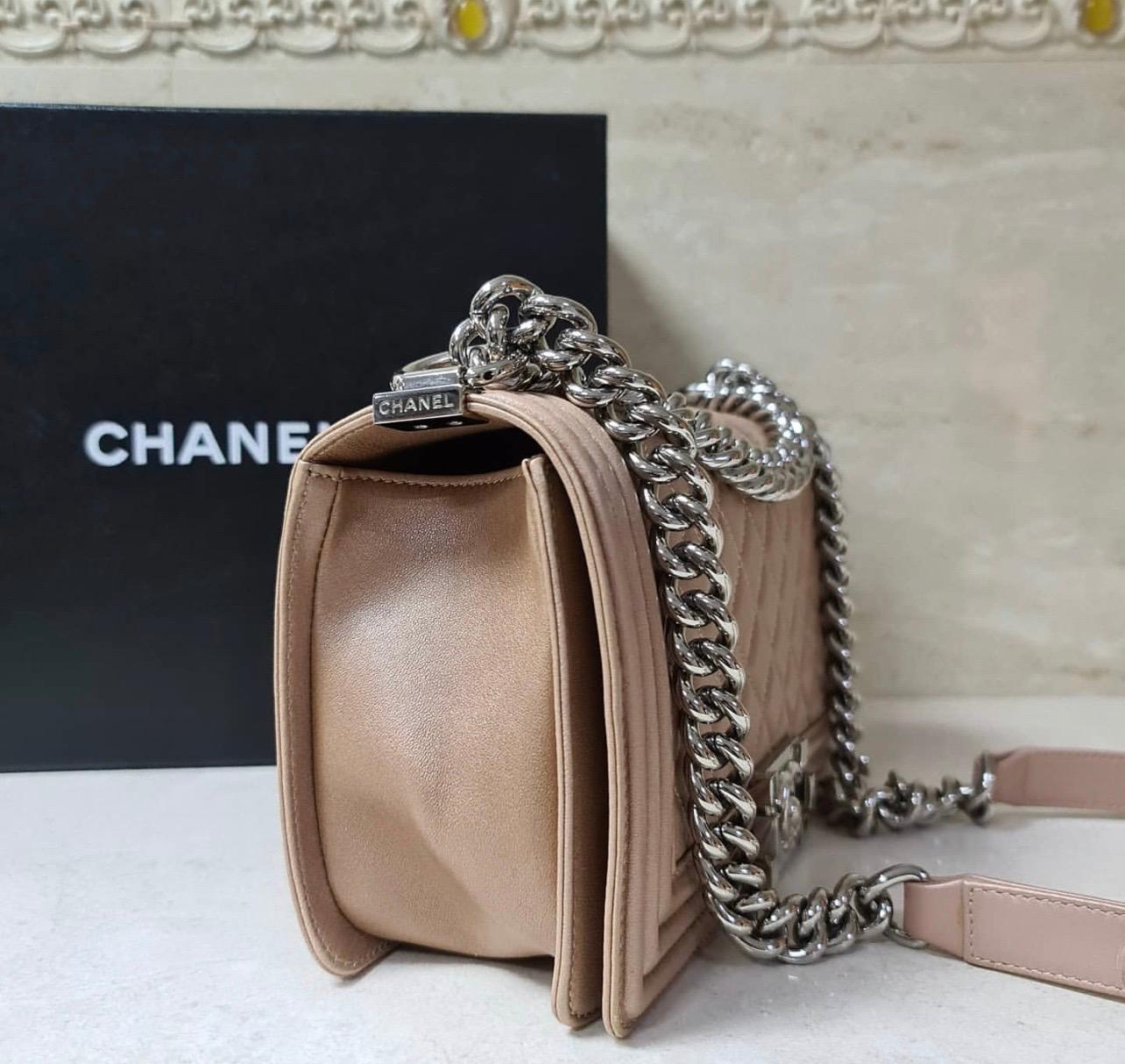 Authentic CHANEL Medium Quilted Boy Bag Iridescent Pearly Rose Gold Calfskin with Palladium Hardware. 

It is a limited edition piece and sold out everywhere — one of the most pearly colours Chanel has ever produced.

This stunning bag is still in