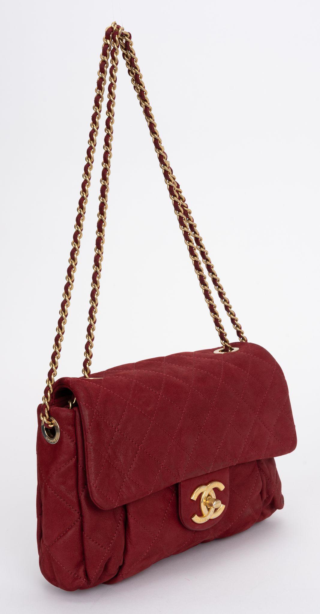 The Chanel Iridescent Calfskin Quilt Flap Bag features a shimmery calfskin quilted leather in red, a gold chain link intertwined leather shoulder strap and a CC turn lock. One interior pocket.
Shoulder drop 9.5