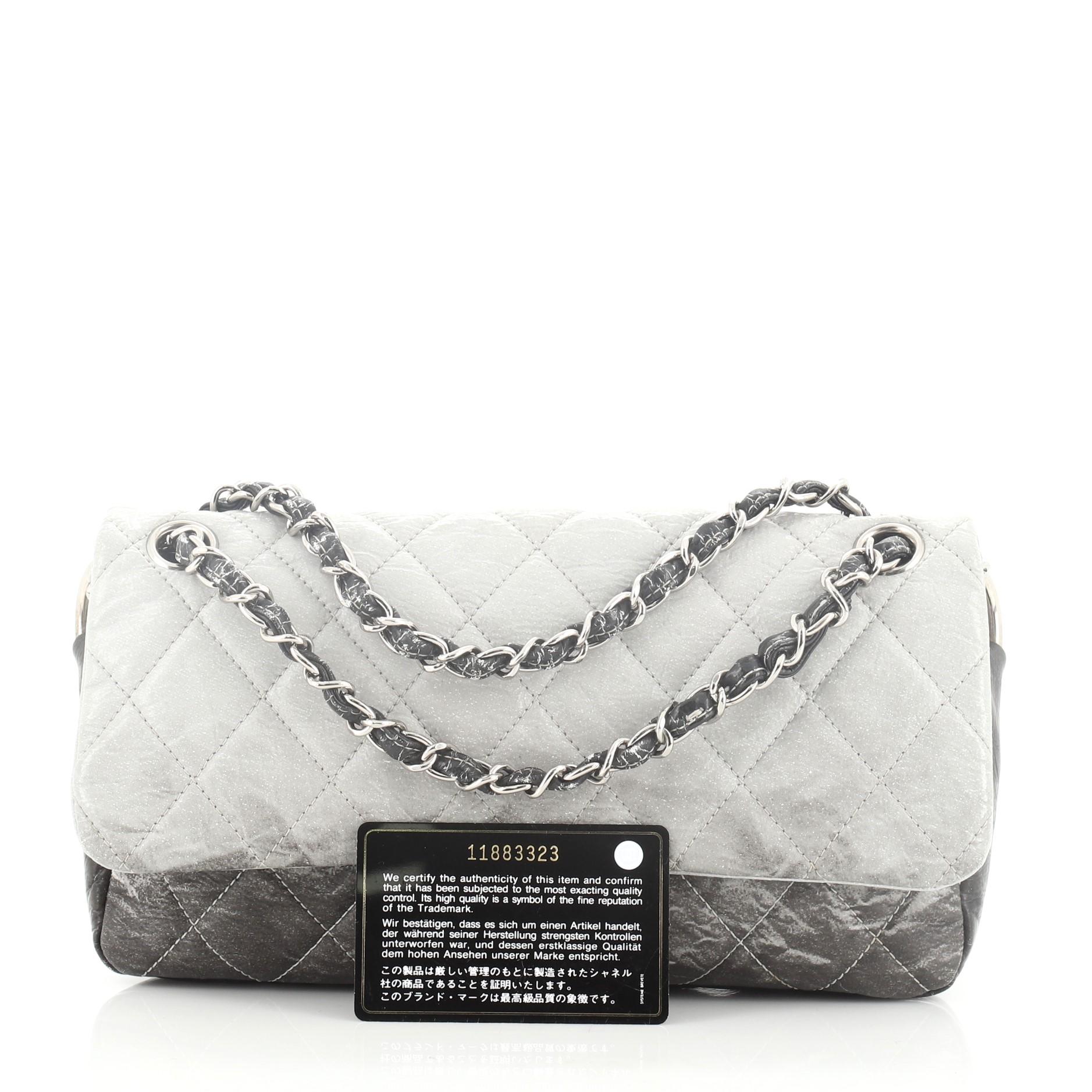 This Chanel Melrose Degrade Flap Bag Quilted Patent Vinyl Medium, crafted in gray and brown quilted patent vinyl, features woven-in patent vinyl chain link strap and silver-tone hardware. Its snap button closure opens to a gray satin interior.