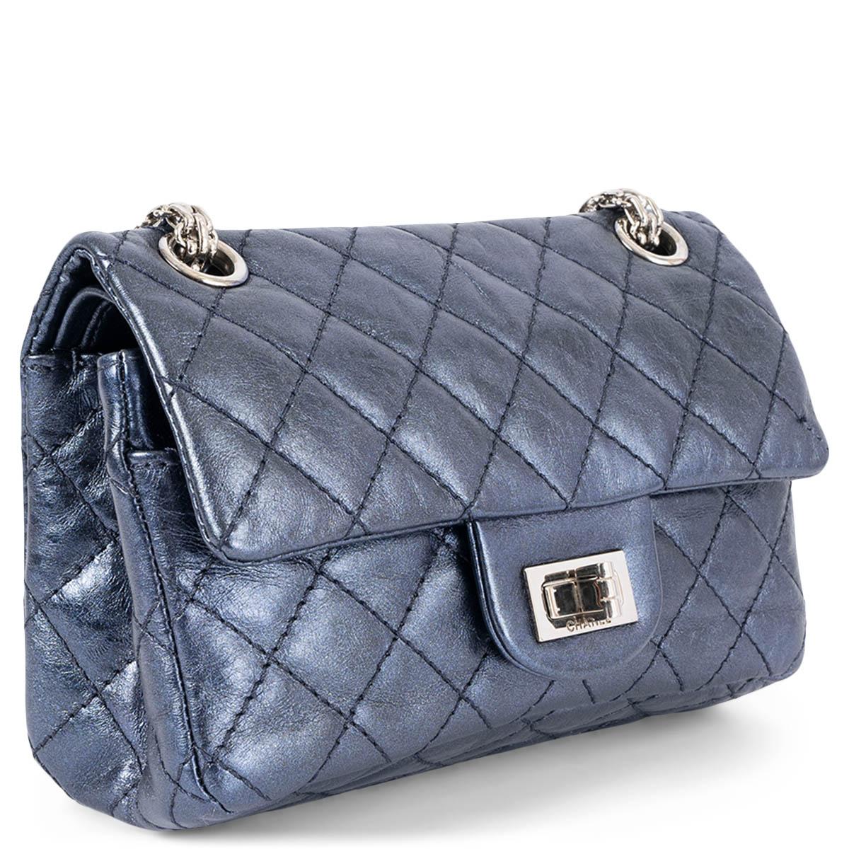 100% authentic Chanel 2.55 Reissue Mini shoulder bag in metallic midnight blue aged calfskin featuring silver-tone hardware. Opens with a classic turn-lock and a flap. Lined in metallic midnight blue smooth calfskin with two patch pockets and one