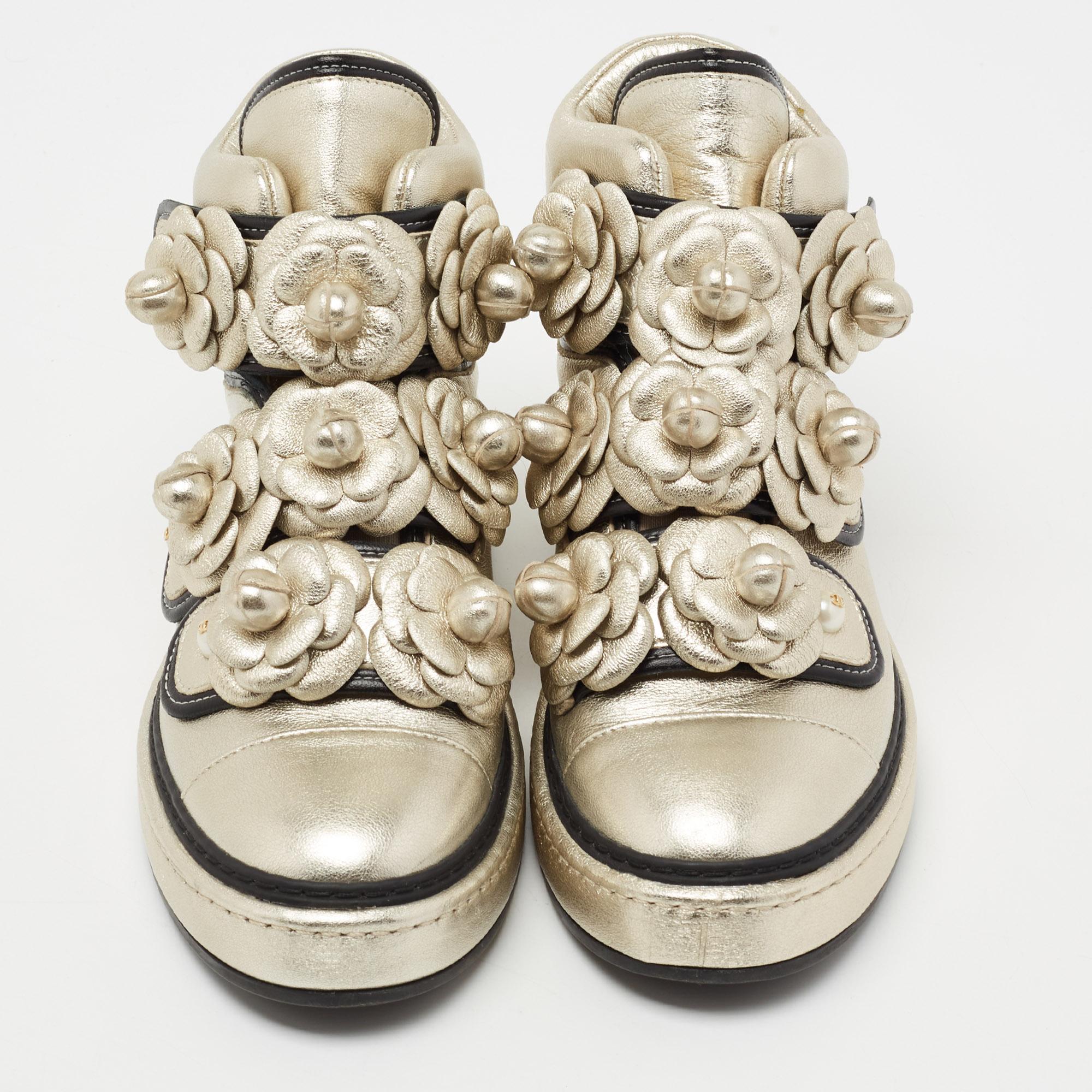 These Chanel sneakers are show-stealers! They've been crafted from leather, styled with velcro straps, and decorated with Camellia flowers on the front. The Camellia was a favorite of 