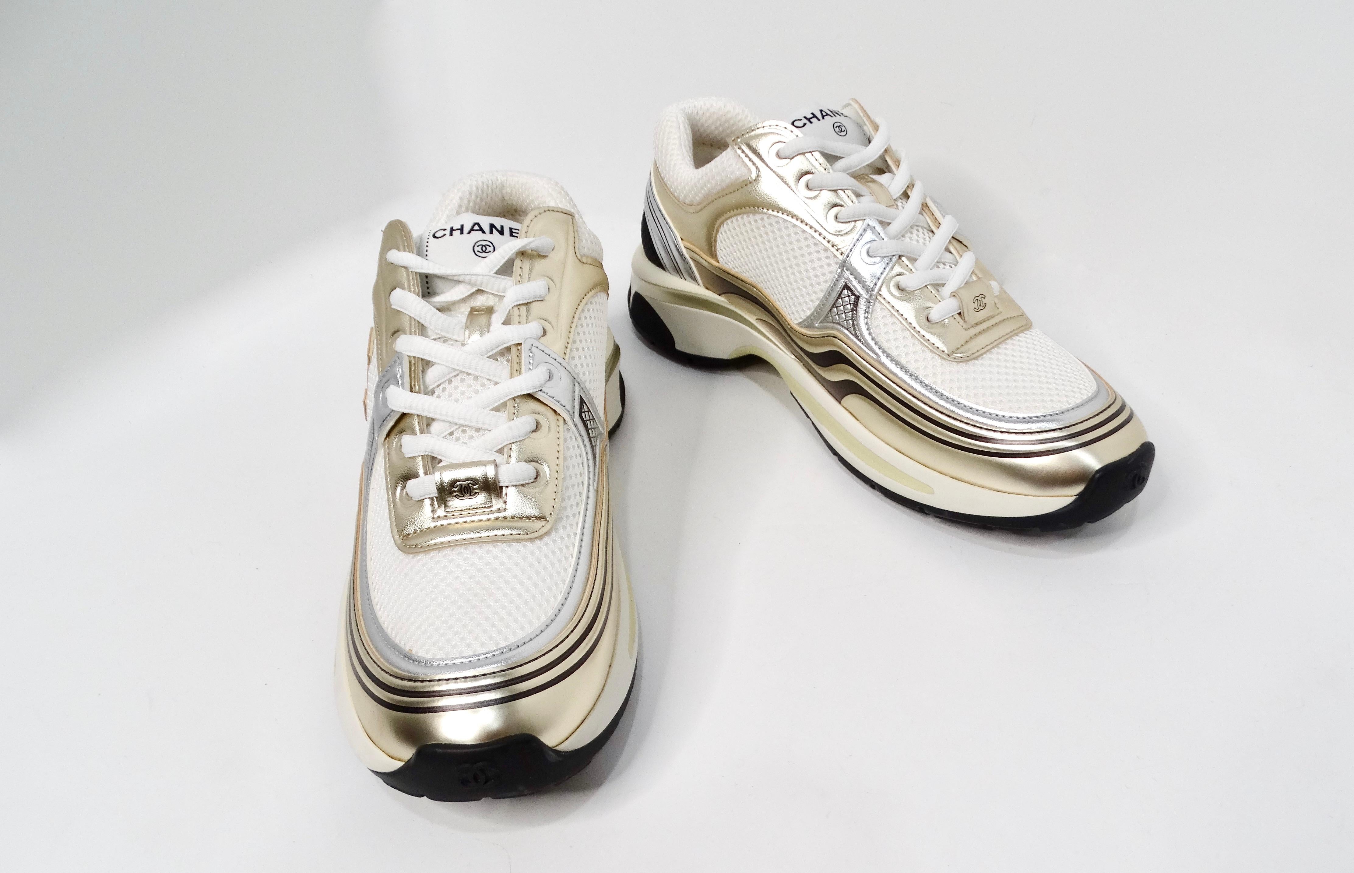 Introducing the exquisite Chanel Metallic Calfskin Stretch Interlocking CC Low-top Sneakers, a perfect blend of luxury and sporty elegance. Crafted from pristine white fabric, these sneakers are accented with stunning metallic gold and silver