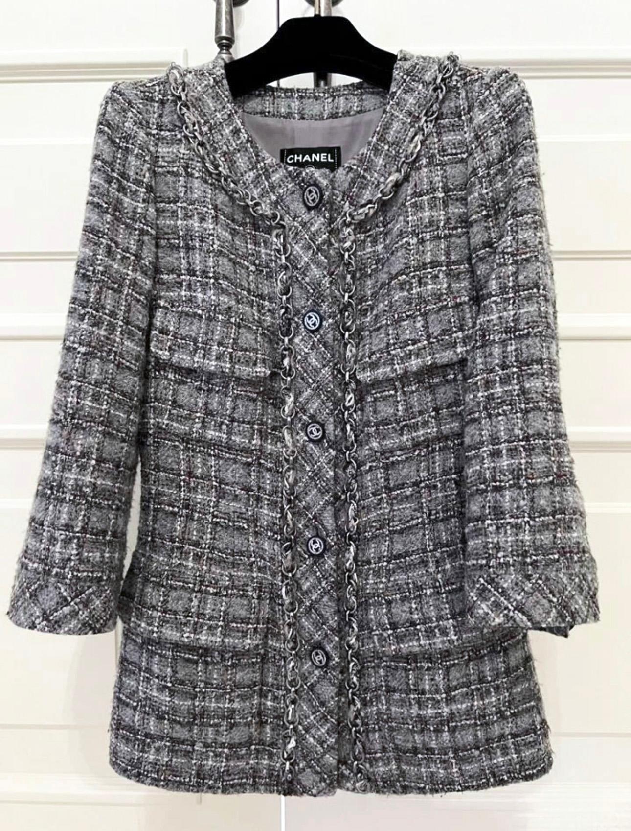Collectible Chanel blueish grey tweed jacket with metallic chain trim throughout.
- CC logo buttons
- tonal silk lining
Size mark 38 FR. Pristine condition.
