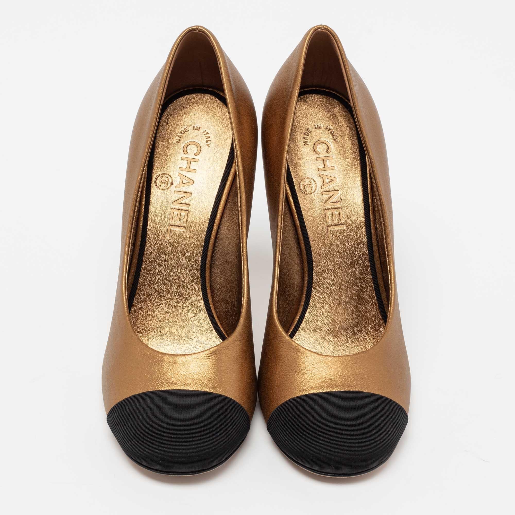 The black cap toes against the metallic gold exterior of this pair of Chanel pumps make for an elegant contrast. Sculpted from leather and fabric, it's 10.5cm heels is detailed with a 'CC' motif, and these shoes are adorned with gold-tone