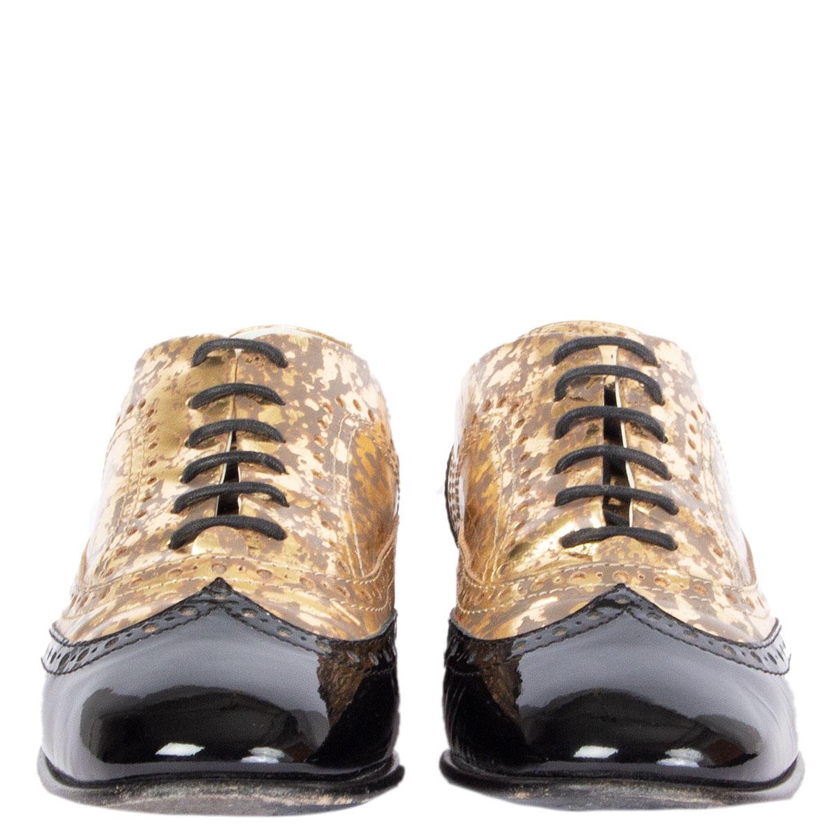 100% authentic Chanel Brogue lace-up Oxford shoes in gold-tone metallic leather and black patent leather brogue detailing tip and heel. Have been worn and are in excellent condition. Come with dust bags. 

Imprinted Size	39.5
Shoe Size	39.5
Inside