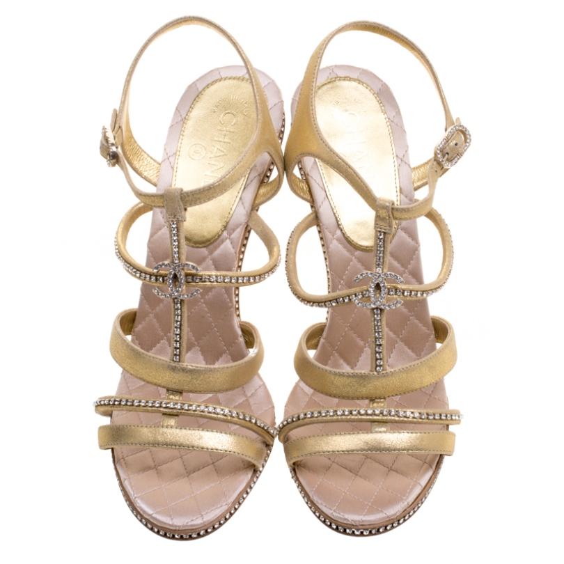 Chanel's designs come with a style that leaves all in awe. Take a look at these sandals! They've been crafted from gold suede in a strappy layout and styled with crystal embellishments and the signature CC. The pair is complete with ankle fastening