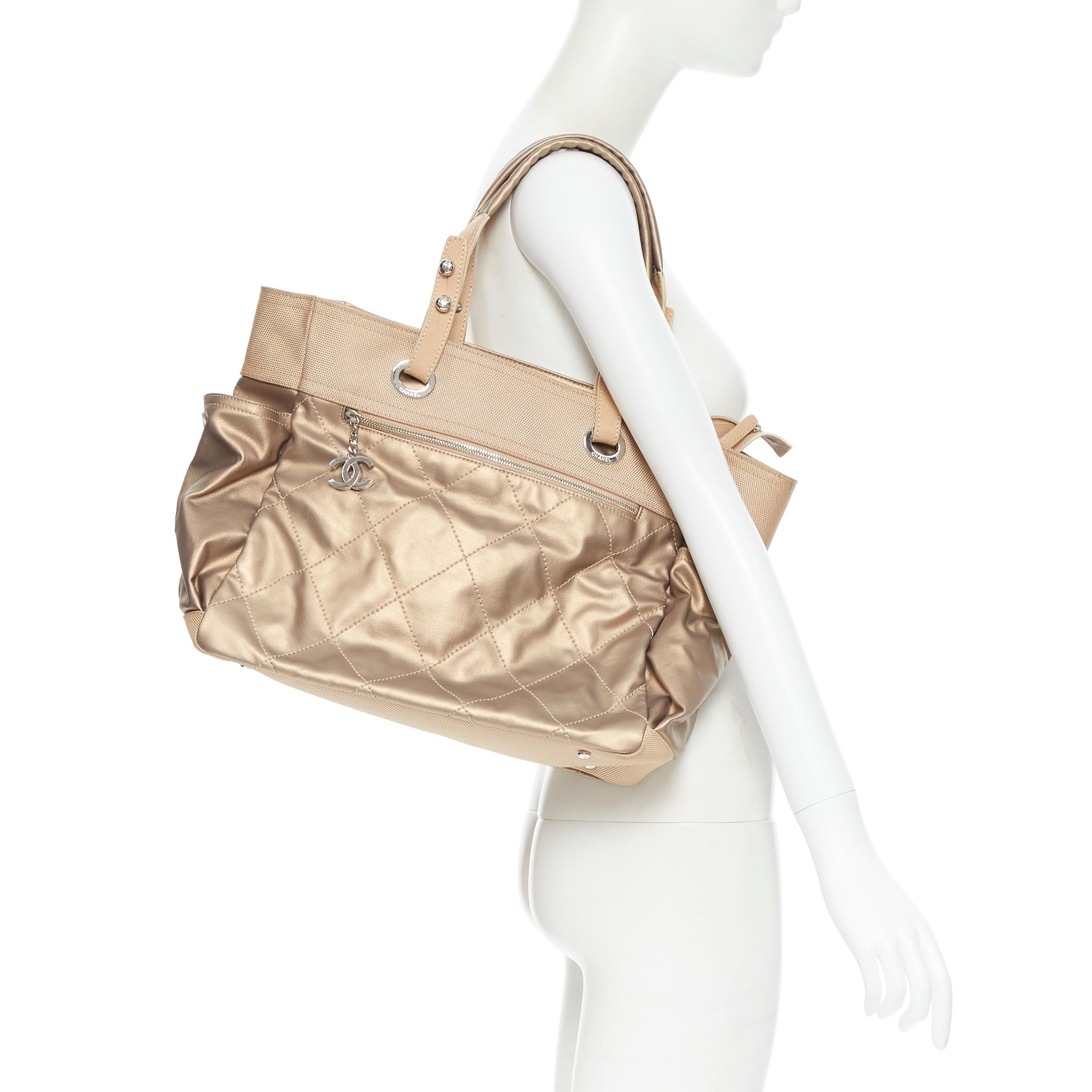 CHANEL metallic gold coated canvas diamond quilted CC zip pull summer tote bag Reference: CAWG/A00189 
Brand: Chanel 
Designer: Karl Lagerfeld 
Model: Gold coated canvas tote 
Material: Fabric 
Color: Gold 
Pattern: Solid 
Closure: Zip 
Extra