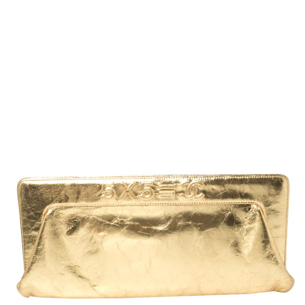 This stunning Ladies First clutch is a timeless piece. Complete a luxurious look with this distressed leather Chanel frame clutch that is perfect for any party or formal event. It features a stunning metallic gold color with a frame with the words