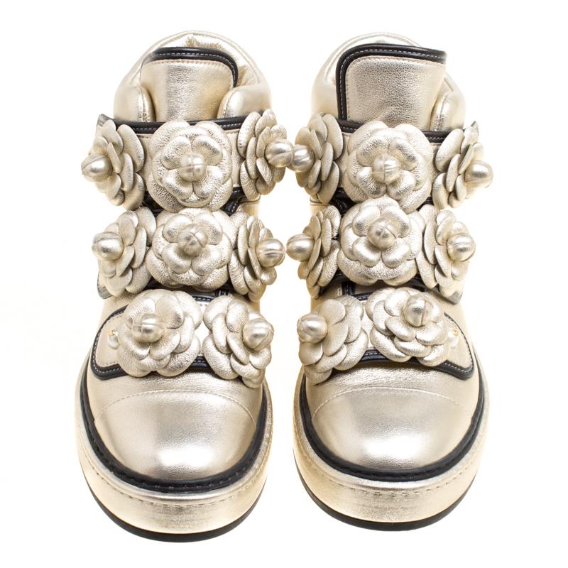 These Chanel sneakers are jaw-droppingly gorgeous. They've been crafted from metallic gold leather, styled with velcro straps and decorated with Camellia flowers and faux pearls on the front. The Camellia was a favourite of 