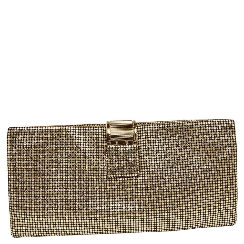 Chanel brings to you this stunning clutch made from perforated leather. The metallic gold hue stands out and truly shines. Featuring the iconic CC on the flap, this foldover clutch has well-sized compartments in the interior. Take it out for your