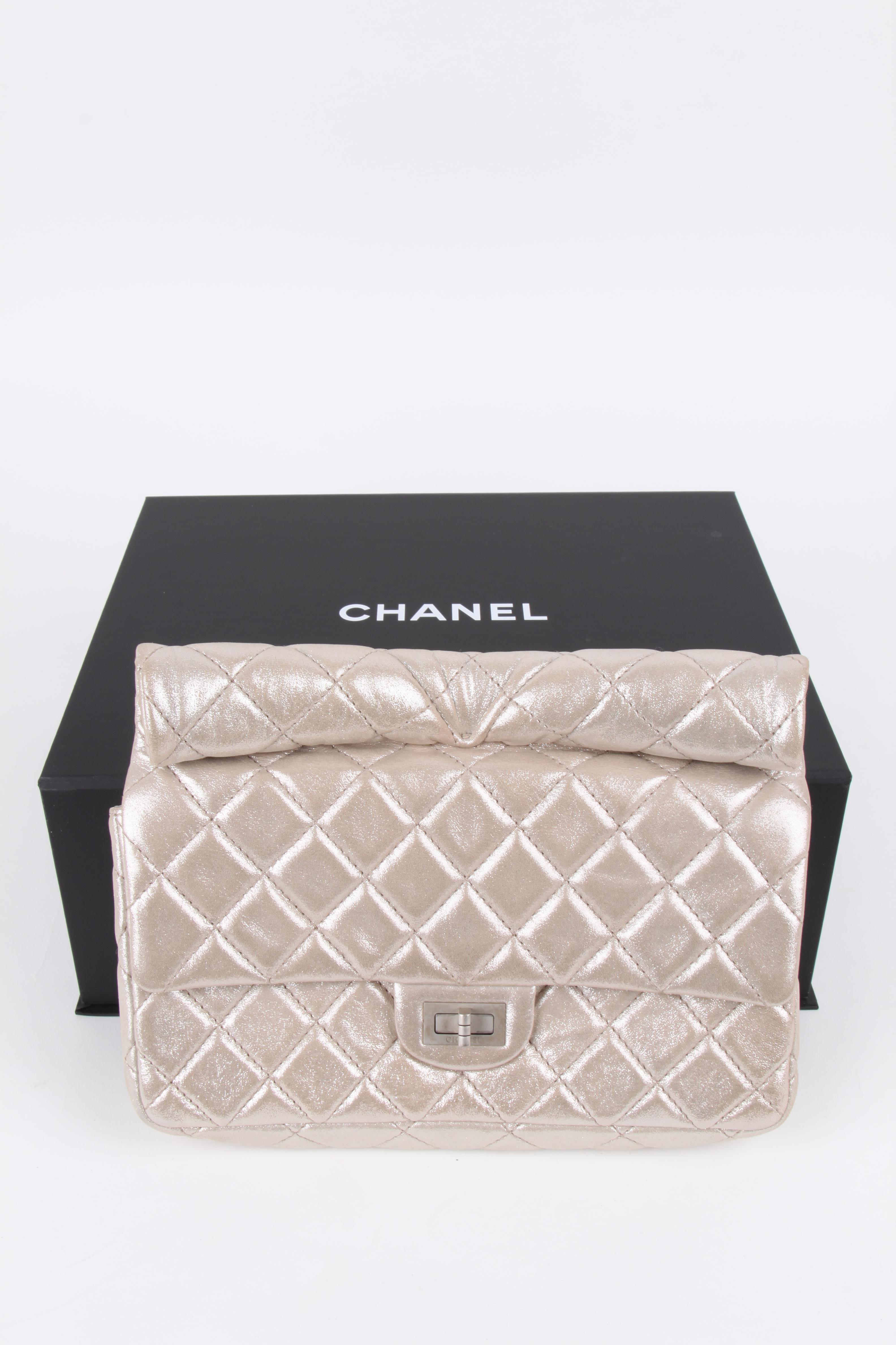 Chanel Quilted Iridescent Calfskin Roll Metallic Pale Gold Clutch. 
MATERIAL: Calfskin leather
HARDWARE: Silver
CONDITION: 9/10
COMES WITH: Box, authenticity card, dustbag
MEASURES: 26 x 21 x 5 cm
ORGIN: Italy 
AVAILABILITY: ready to ship