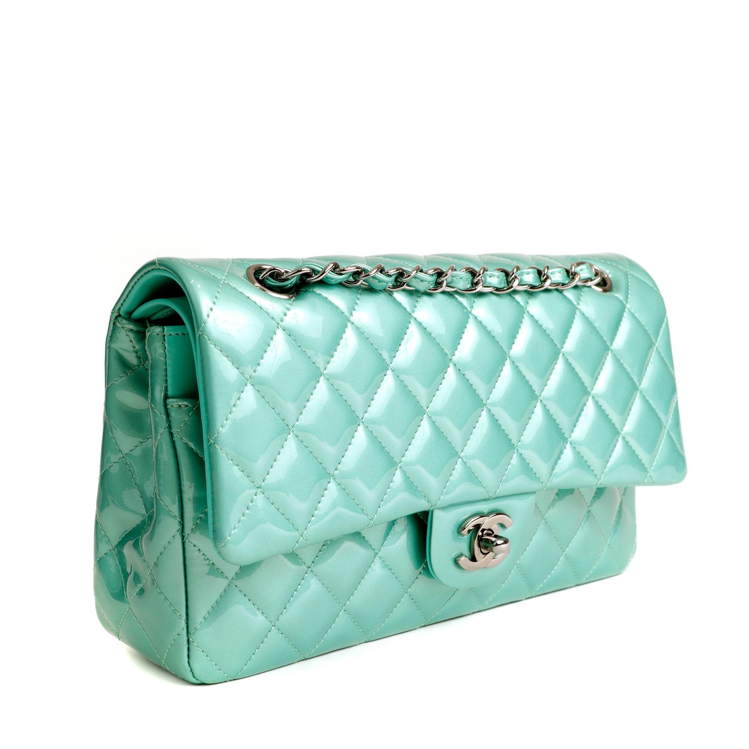 This authentic Chanel Mint Green Patent Leather Medium Classic Flap Bag is in pristine condition, appearing never carried.  A key piece in any sophisticated wardrobe, the Classic Flap is one of the most sought-after Chanel styles produced.
Durable