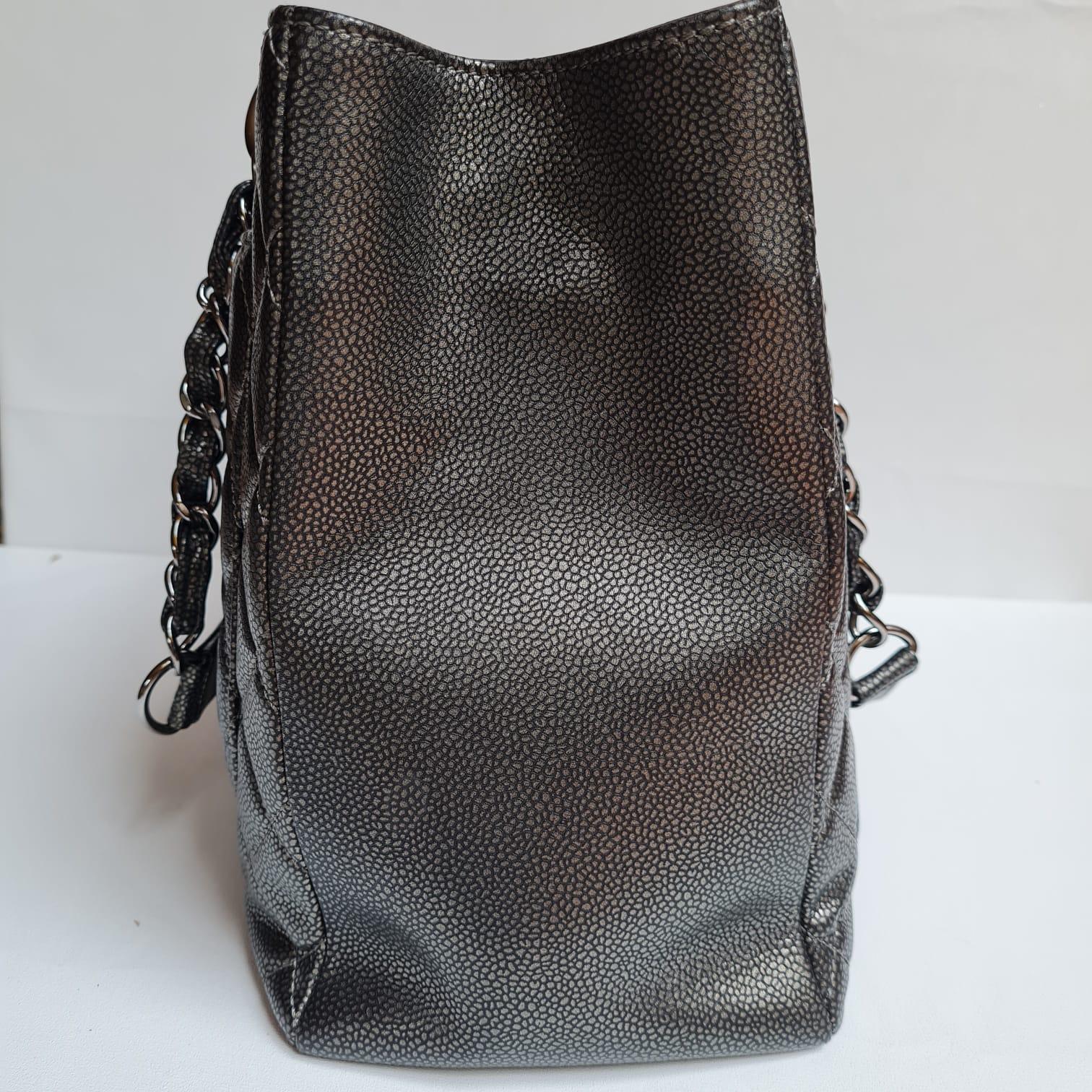 Classic grand shopping tote in gunmetal caviar leather. Item is in great condition, but the outside leather has slightly caved in due to storage. Minor rubbing on the corners. Item comes with no inclusion. Item series #15.