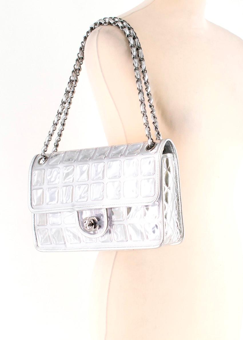Chanel Metallic Ice Cube Limited Edition Flap Bag

- Leather and chain-detailed strap
- Flap top with push-lock button 
- Signature 'cc' metal logo plaque on flap
- Plastic and metal box design
- Internal zip pocket
- Silver-tone hardware

Please
