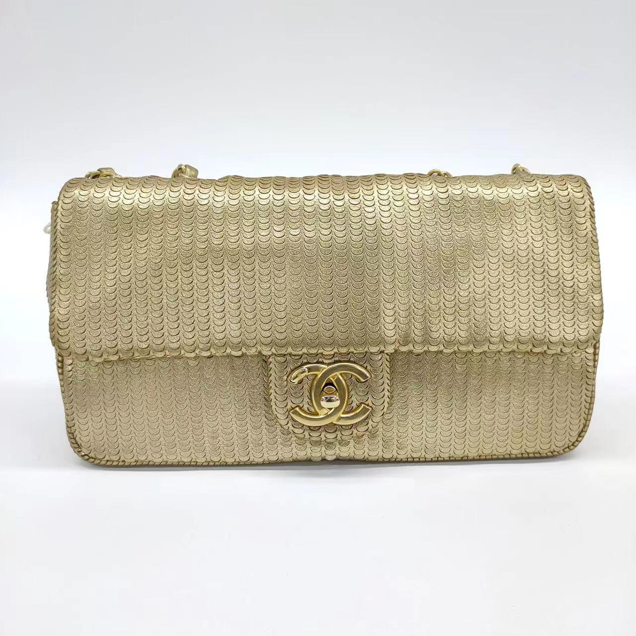 Chanel Metallic Lambskin Laser Cut Medium Gold Classic Flap Bag These are professional photos of the actual bag offered by Luxbags. This is a genuine CHANEL Metallic Lambskin Laser Cut Medium Gold 2014 Classic Flap Bag. Crafted with high-quality