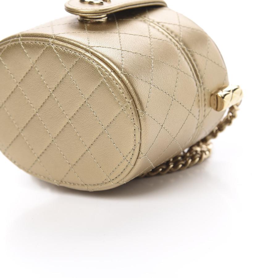 This stylish crossbody is crafted of luxurious quilted lambskin leather in gold. The bag features a leather threaded gold chain-link shoulder strap and gold hardware. The handbag opens to a gold fabric interior with a mirror. This is an excellent