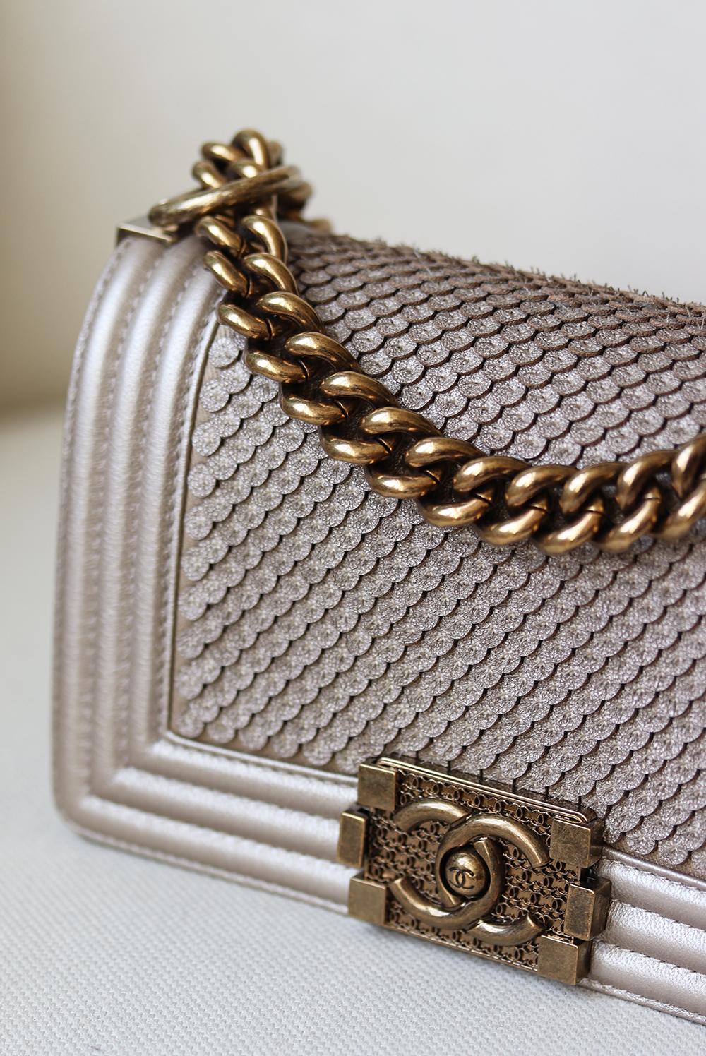Chanel Metallic Lambskin Boy Crossbody Bag has been hand-finished by skilled artisans in the label's workshop.
Boasting a textured scaled lambskin exterior, this design is accented with gold-toned and metallic calfskin chain strap.
Made in France