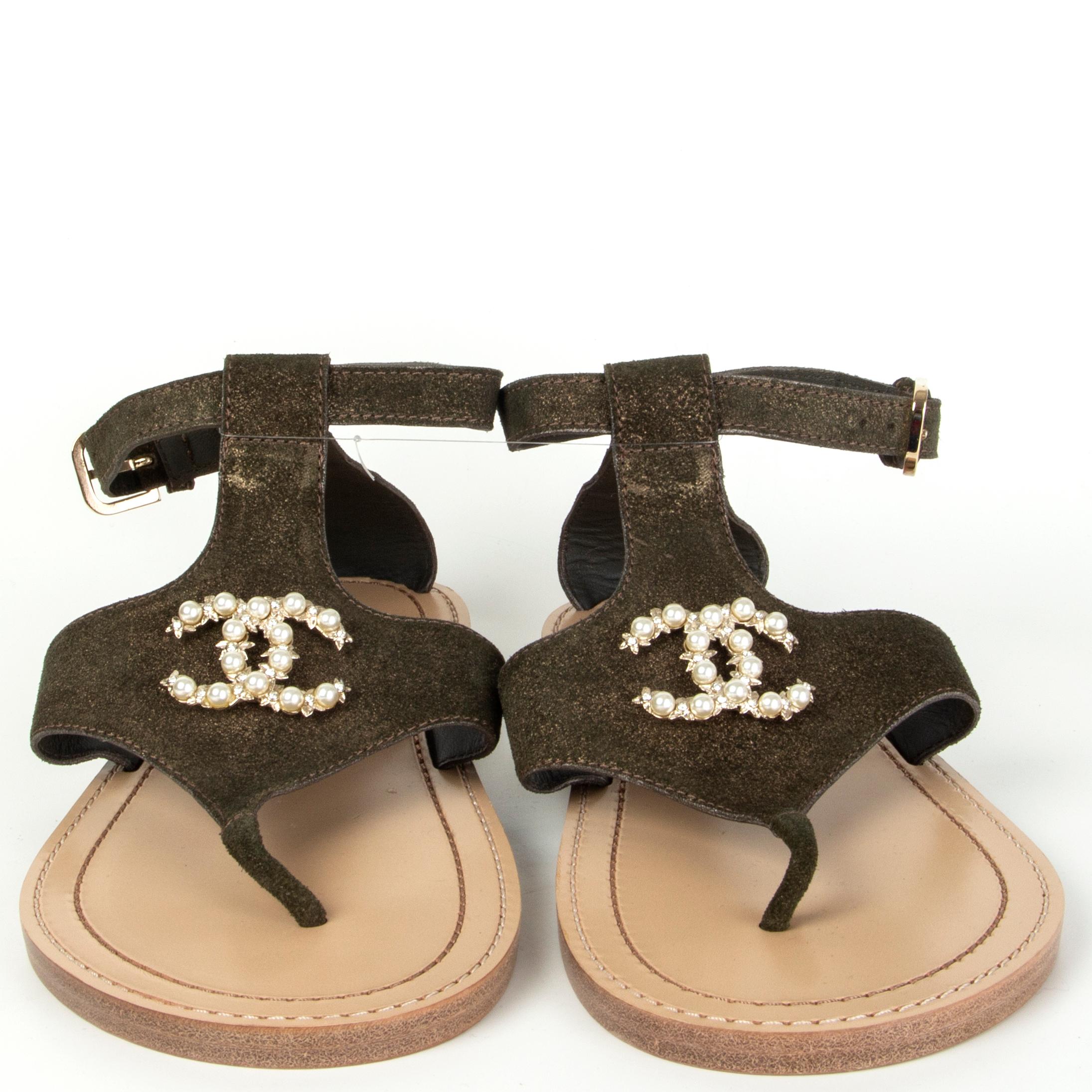 100% authentic Chanel thong sandals in metallic golden olive green suede embellished with off-white faux pearls. Brand new. Come with dust bag. 

Measurements
Imprinted Size	38.5
Shoe Size	38.5
Inside Sole	25cm (9.8in)
Width	10cm (3.9in)

All our