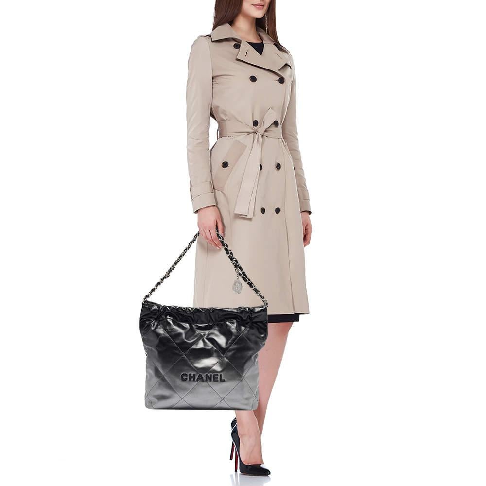 The Chanel 22 hobo is a luxurious and stylish handbag. Its soft  leather is adorned with the iconic quilted pattern. The bag features a hobo style silhouette with a comfortable shoulder strap and the classic Chanel logo  exuding timeless elegance
