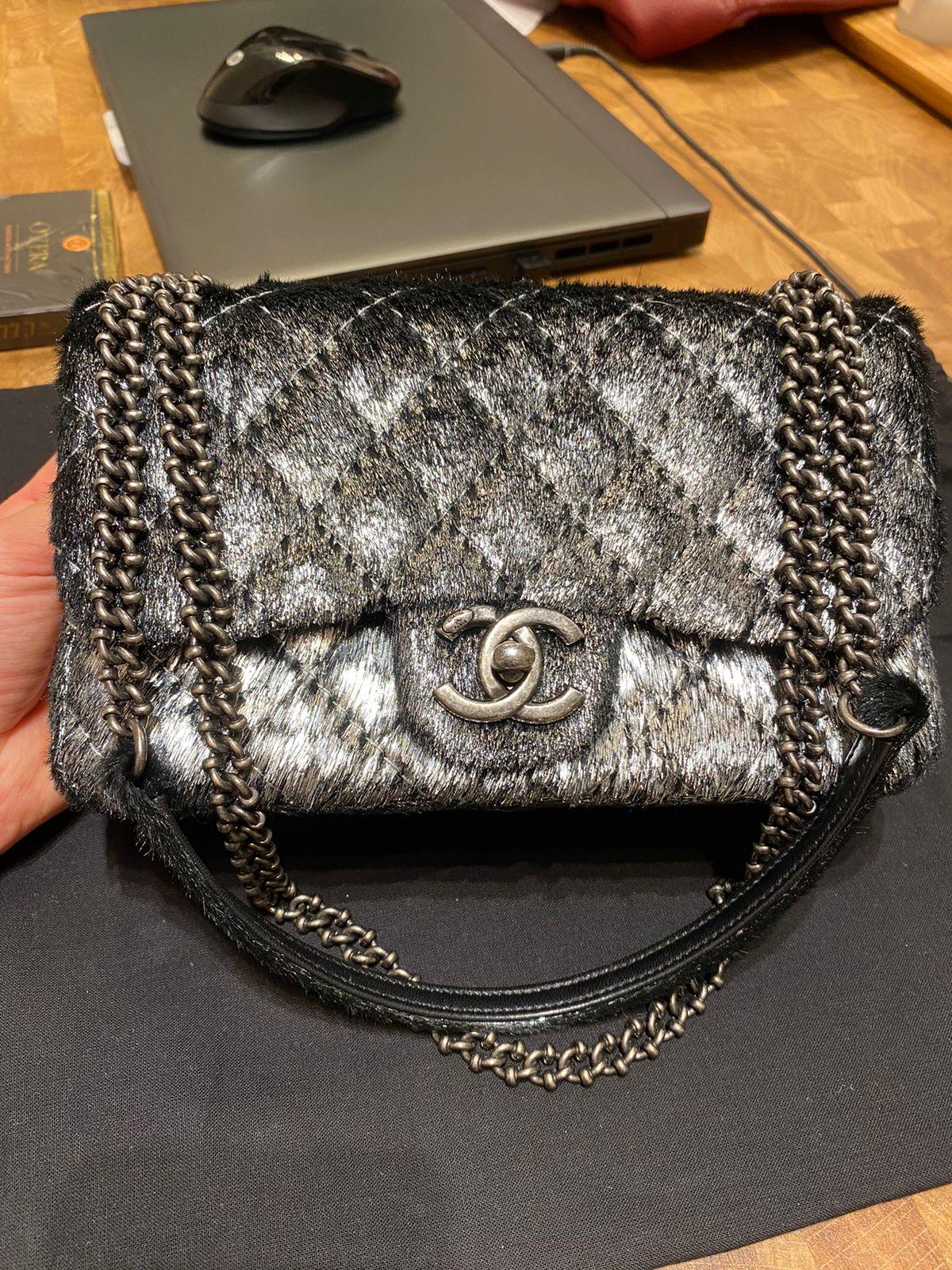 CHANEL Metallic Pony Hair Quilted Flap bag n Dark Silver. The exceptional features and superior quality of this Chanel shoulder bag create a bold and one of a kind look for evening. The bag is a smaller classic flap bag and is beautifully crafted of