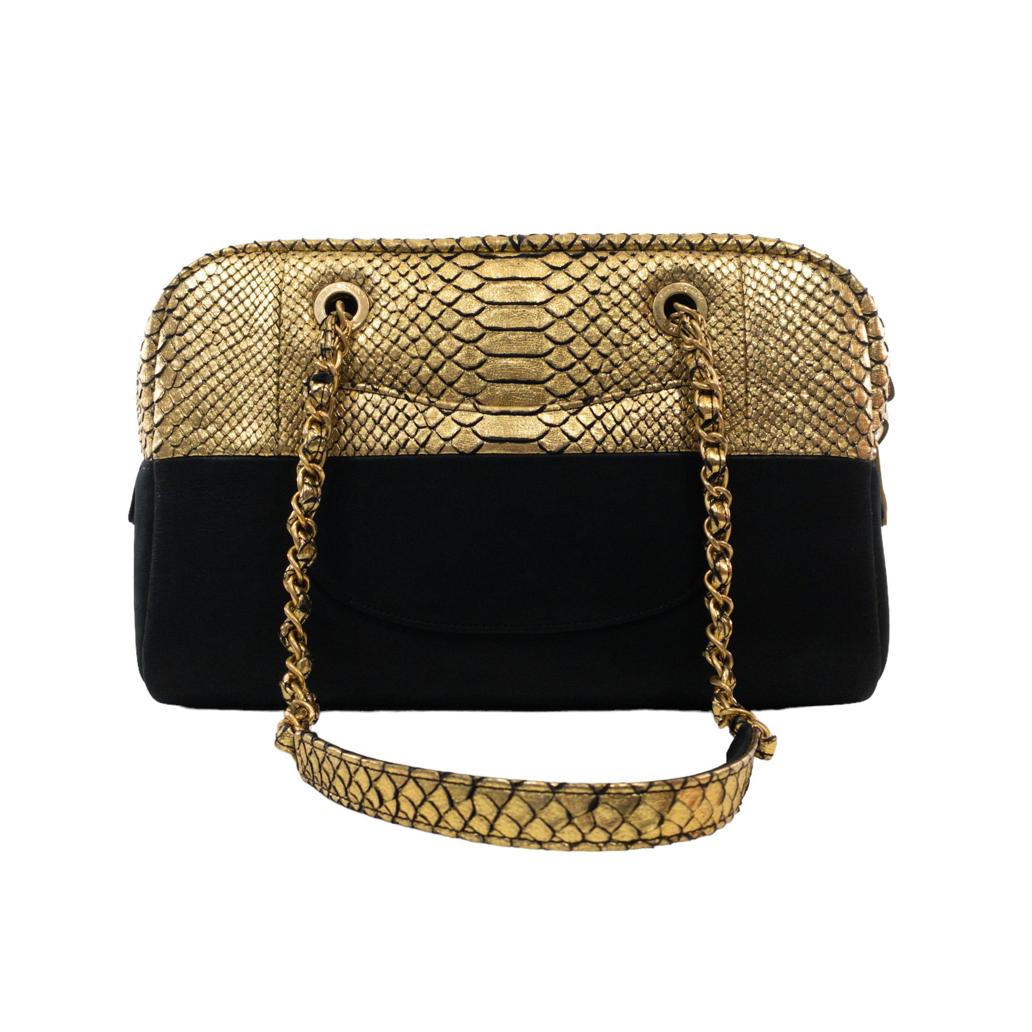 Chanel Metallic Python Suede Bowler Tote Bag

This is an Authentic Chanel Bicolor Python and suede bowler bag. Metallic gold painted snakeskin with black suede. Two woven chain straps with zipped top opening. CC charm on front strap. Large interior