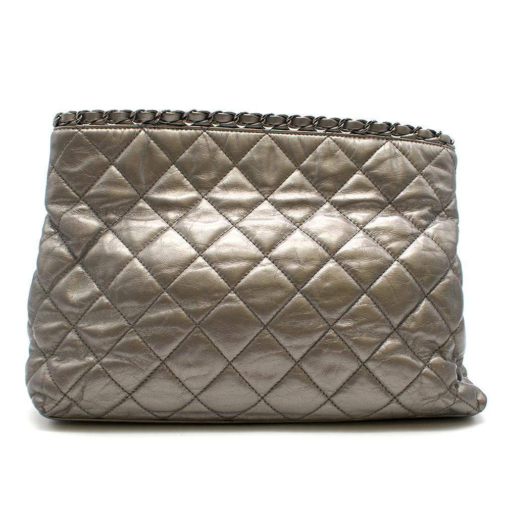 Chanel Metallic Silver Chain Me Tote Bag

- CC logo on the front 
- Metallic aged leather
- Leather and metal entwined trim at the top of bag and handle 
- Two compartments with zipped pocket in the middle 
- Magnetic closure 

This bag can be