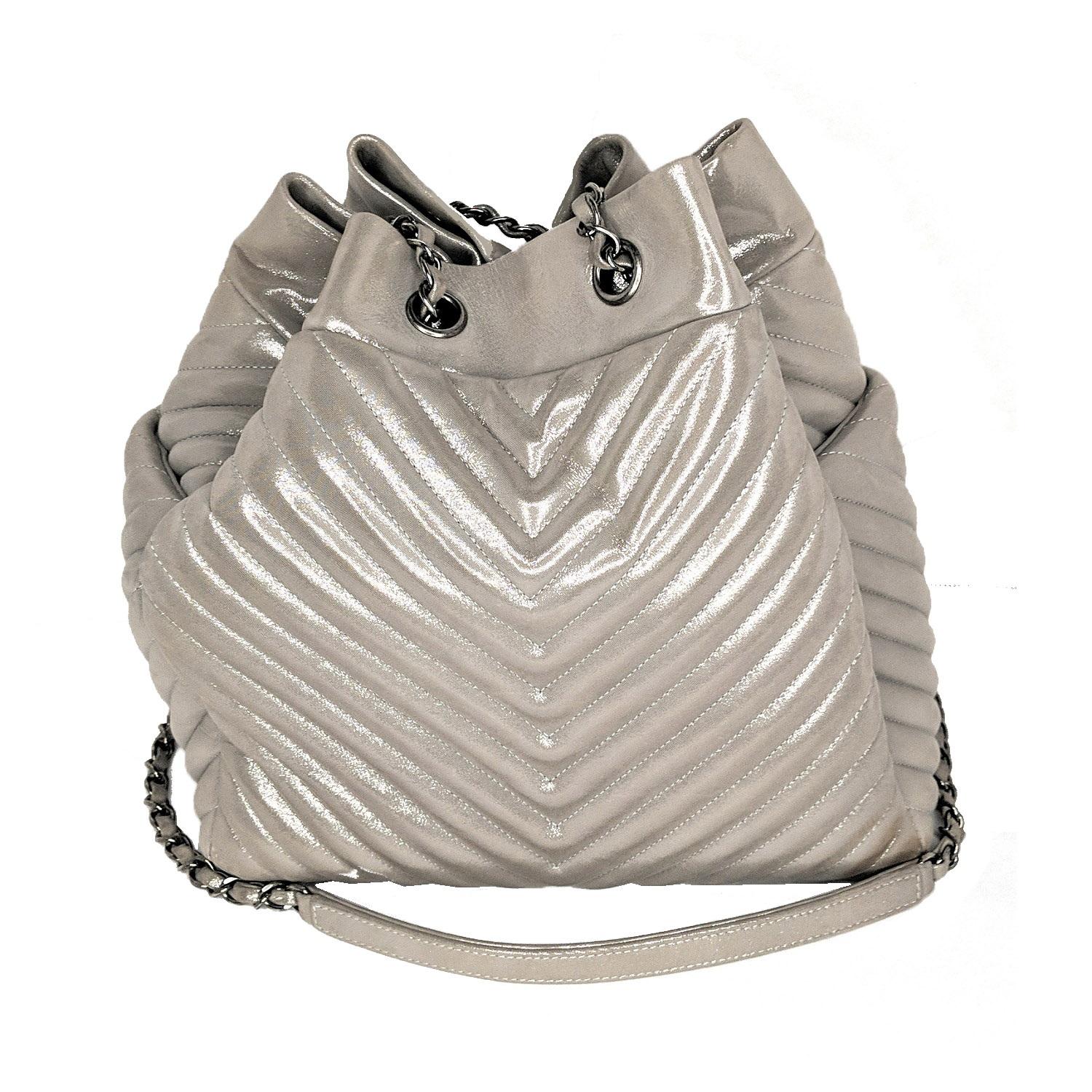 From the Spring/Summer 2016 Act 2 Bag Collection. Iridescent silver-tone chevron quilted leather Chanel Large Urban Spirit bucket bag with ruthenium hardware, single chain-link and leather shoulder strap with leather shoulder guard, interlocking CC