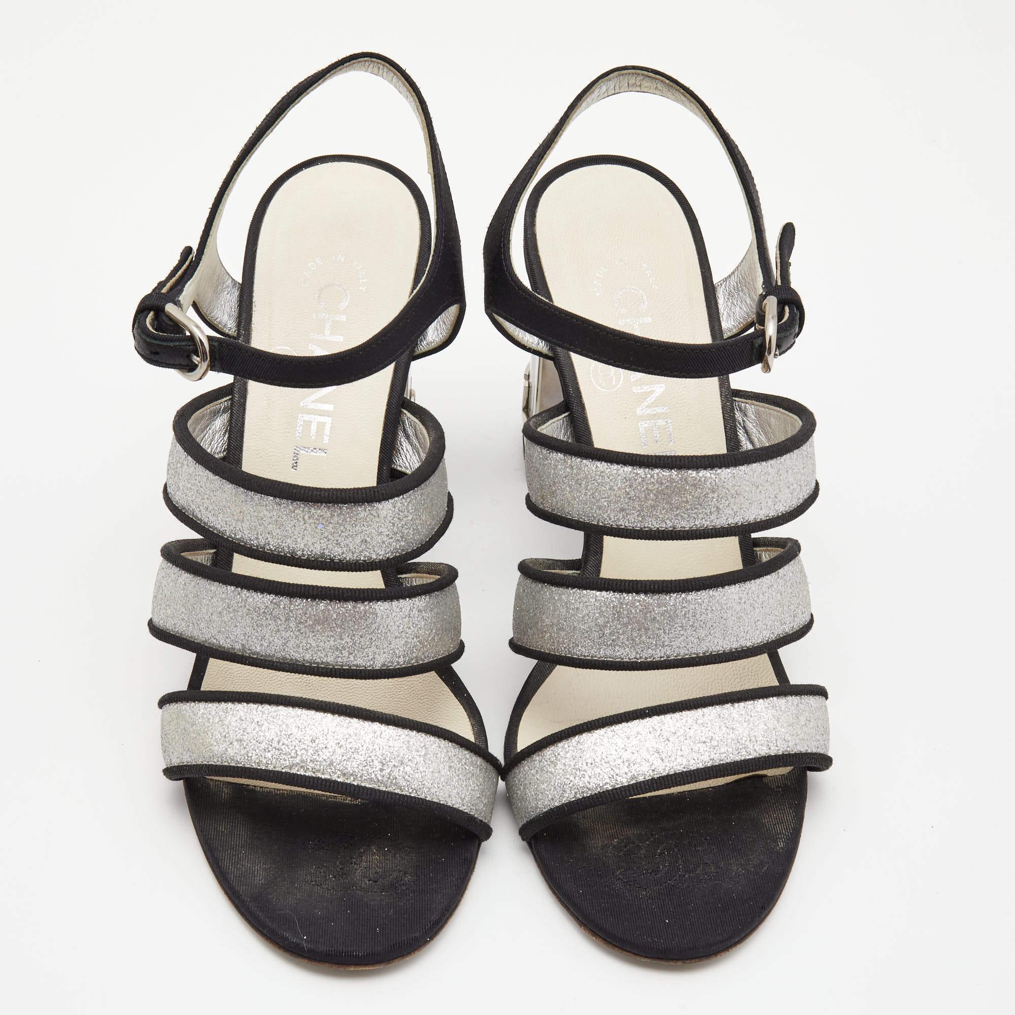Mixing the classic Chanel sophistication with a modern look, these sandals are a perfect choice for those special occasions and parties. Constructed in metallic silver glitter leather and fabric trims, these sandals feature a strappy front for a