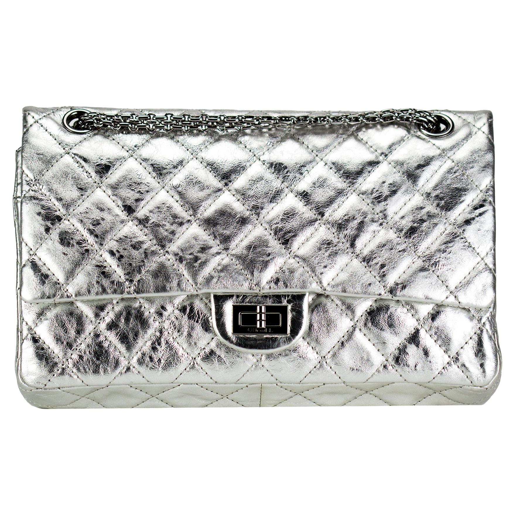 Metallic silver aged calfskin reissue flap with gunmetal hardware 

{2006 VINTAGE 16 Years}
Interior flap closure
Mademoiselle clasp closure
Interior flap zipper pocket
Five interior pockets
Interior gunmetal lining
Classic back pocket
7