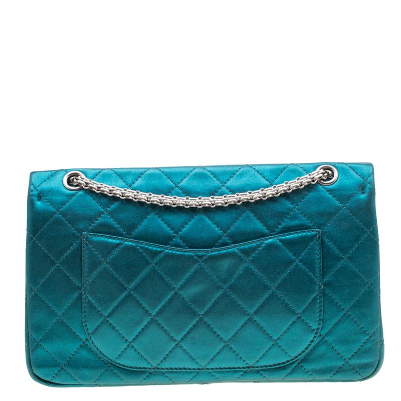 Chanel's Flap Bags are iconic and monumental in the history of fashion. This Reissue 2.55 Classic 227 is a buy that is worth every bit of your splurge. Exquisitely crafted from metallic turquoise leather, it bears their signature quilt pattern and