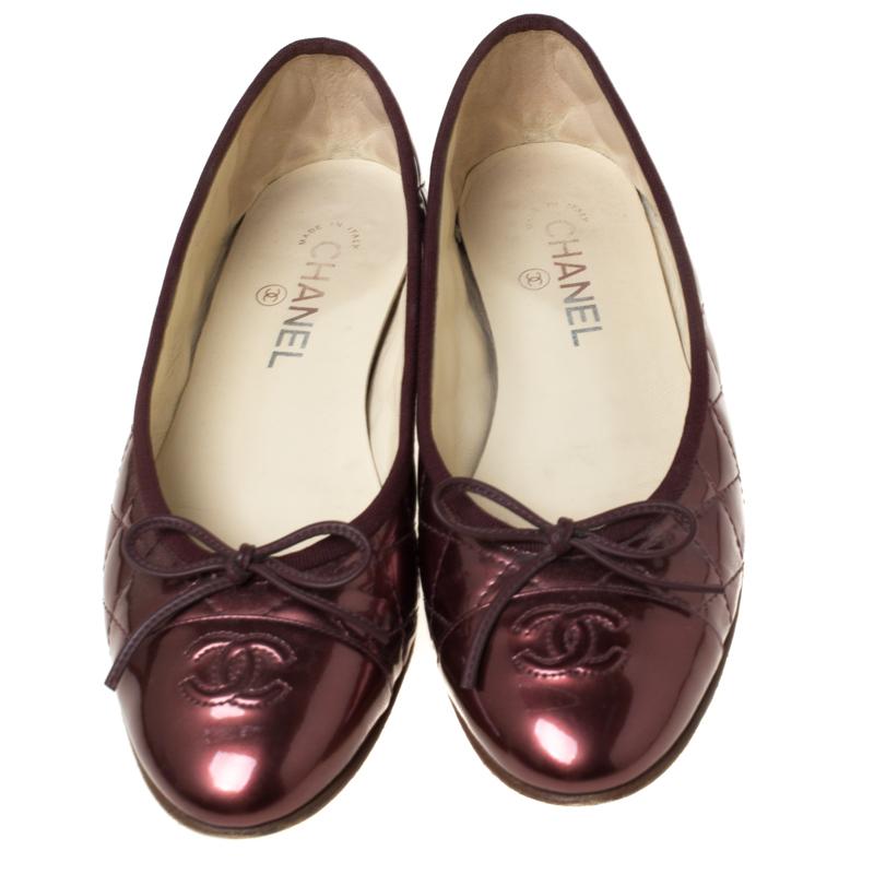 Exclusive and fierce, this pair of Chanel flats will complete any look. Their quilted metallic brown patent leather exterior comes with smooth toe caps featuring the CC stitch. These minimum heel flats feature vamps, adorned with dainty leather bow
