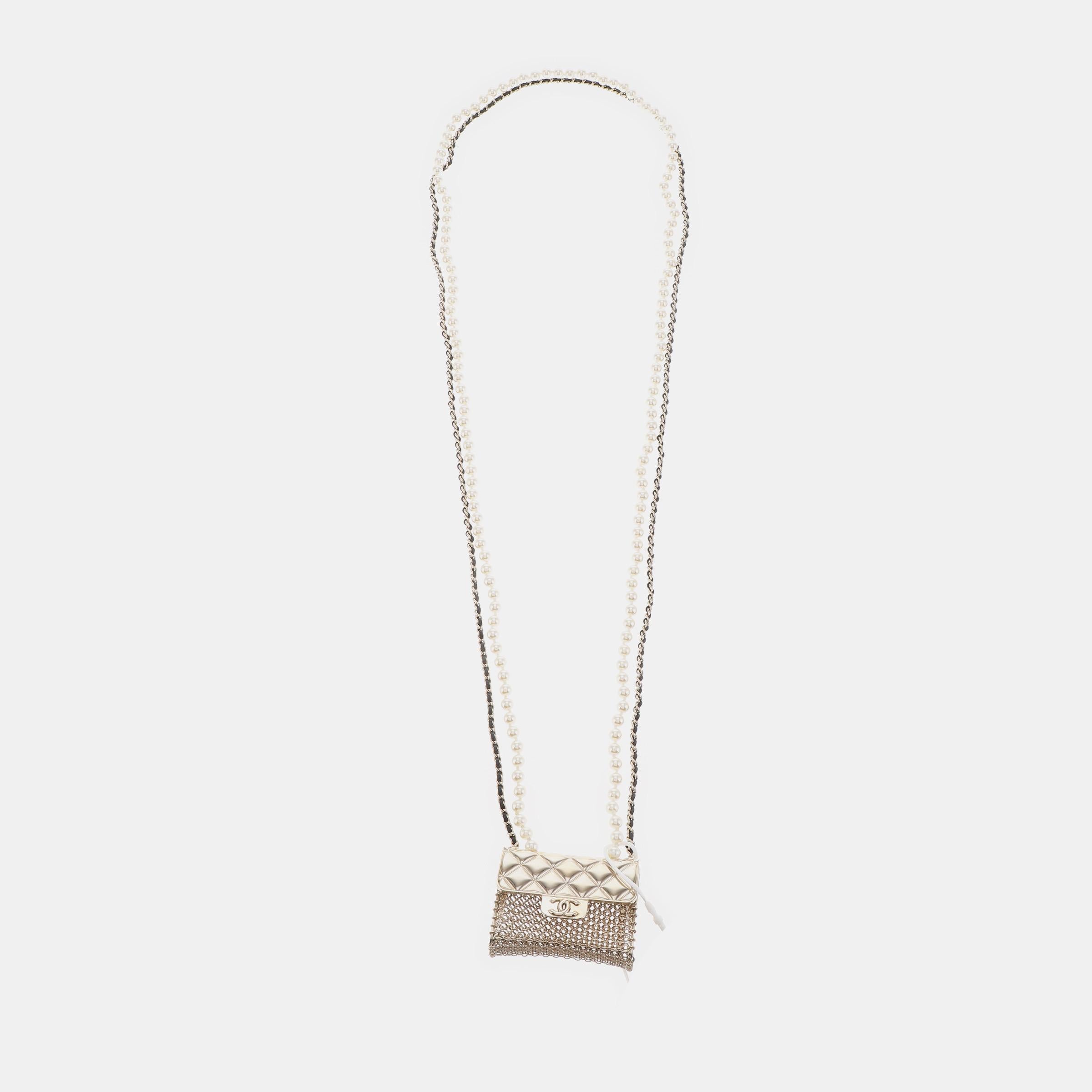 The Chanel Micro Flap Bag Charm Chain Choker Necklace seamlessly blends the essence of the iconic brand's jewelry and handbags. Crafted from intricately linked gold-tone metal rings, this collector's piece features a quilted metal flap and the