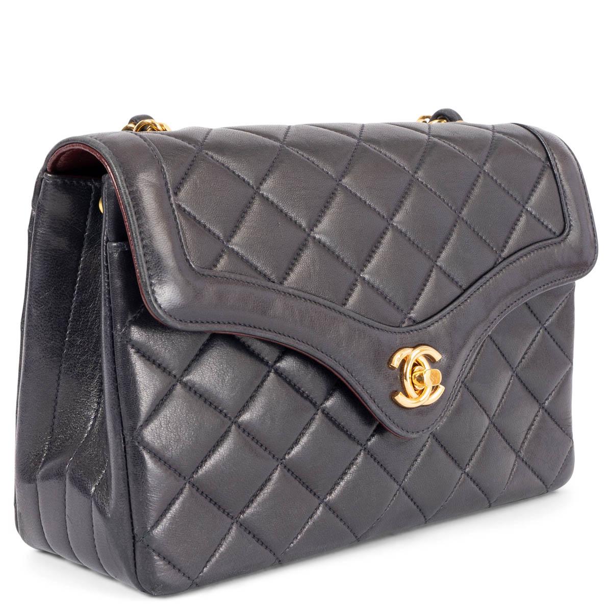 100% authentic Chanel Vintage quilted CC turn-lock flap bag in midnight blue lambskin with gold-tone hardware. Lined in burgundy leather with one zipper pocket, two slit pockets and one lipstick pocket in the middle. Has been carried and shows some