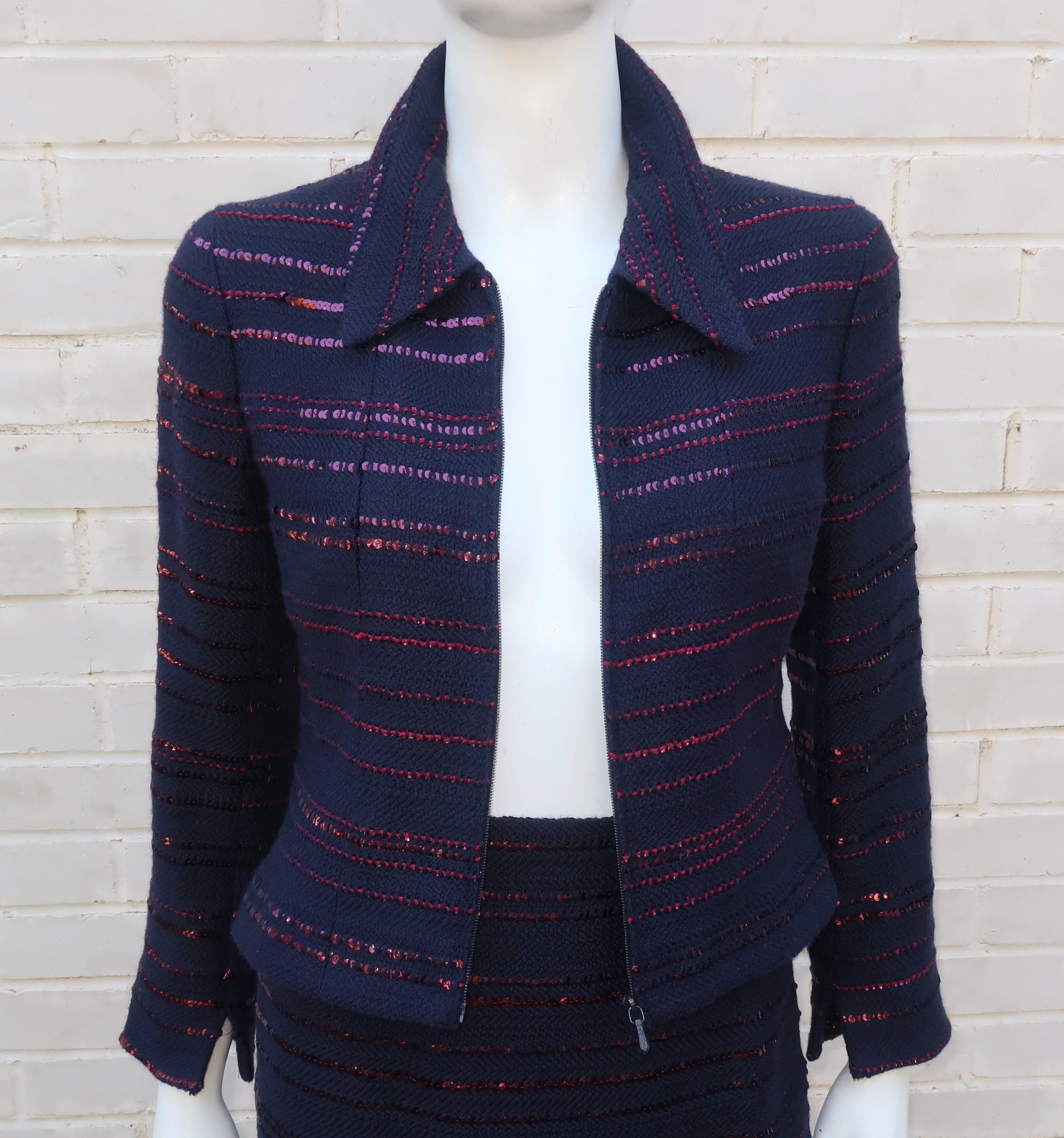 Chanel midnight blue (almost black) two piece skirt and jacket suit in a boucle style wool and cotton blend fabric with rows of horizontal deep ruby red sequins.  The fitted jacket zips at the front with vents at the cuffs and the modified a-line