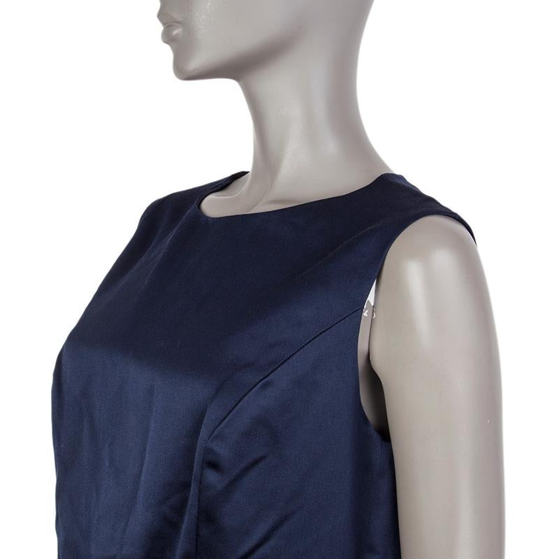Chanel sheath dress in midnight blue silk (100%). With gold-piped waist, diagonal pleats on the skirt, and decorative rhinestone CC button on the back of the neck. Closes with hook and invisible zipper on the back. Lined in midnight blue silk