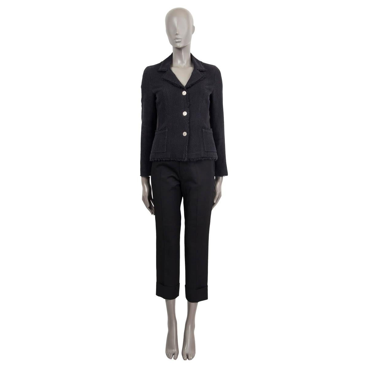 100% authentic Chanel single breasted wide notch jacket in midnight blue structured wool (86%) and silk (14%) featuring frayed edges, two front patch pockets, 3 CC silver-tone metal buttons and cuff link style buttons on the cuff. Lined in black