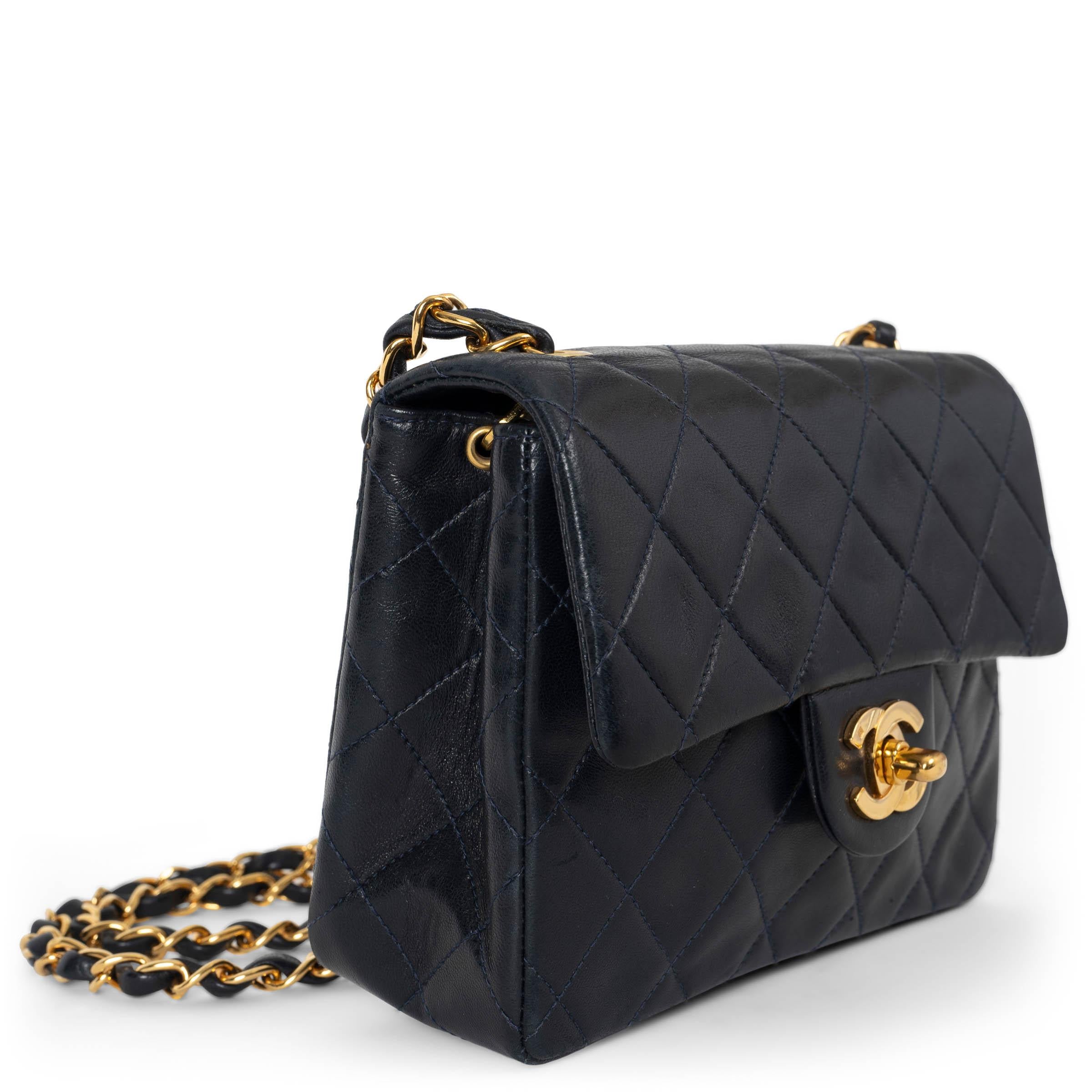 This 100% authentic Chanel Mini Square Flap Bag in midnight blue lambskin is a classic piece that combines elegance with timeless Chanel design. Featuring luxurious gold-tone hardware, the bag showcases the iconic front flap with CC turnlock