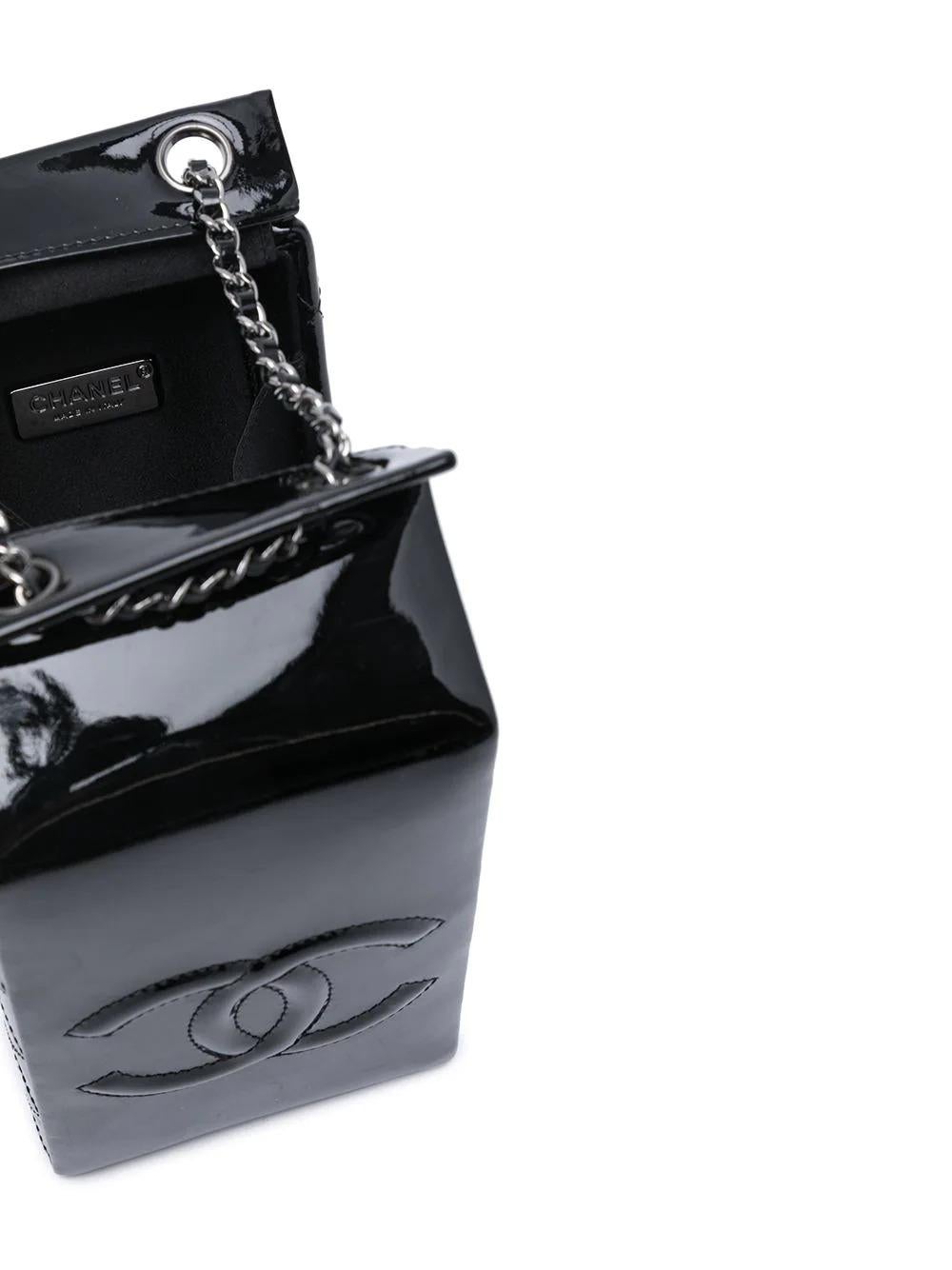 Got milk? This limited edition Chanel milk carton bag derives from one of Karl Lagerfeld's most infamous runway stagings of all time, the supermarket emporium of Autumn/Winter 2014. Its iridescent black leather is detailed with quilted side panels,