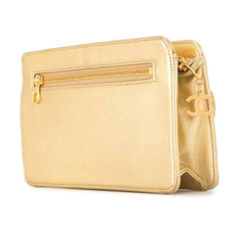 Chanel Mini Vintage 1997 Metallic Gold Rare Evening CC Charm Clutch

Gold hardware
Metallic gold-tone lambskin leather vintage 
Single wristlet strap at side
Three pockets at exterior
Two with zip closures
Tonal leather interior
Dual pockets at