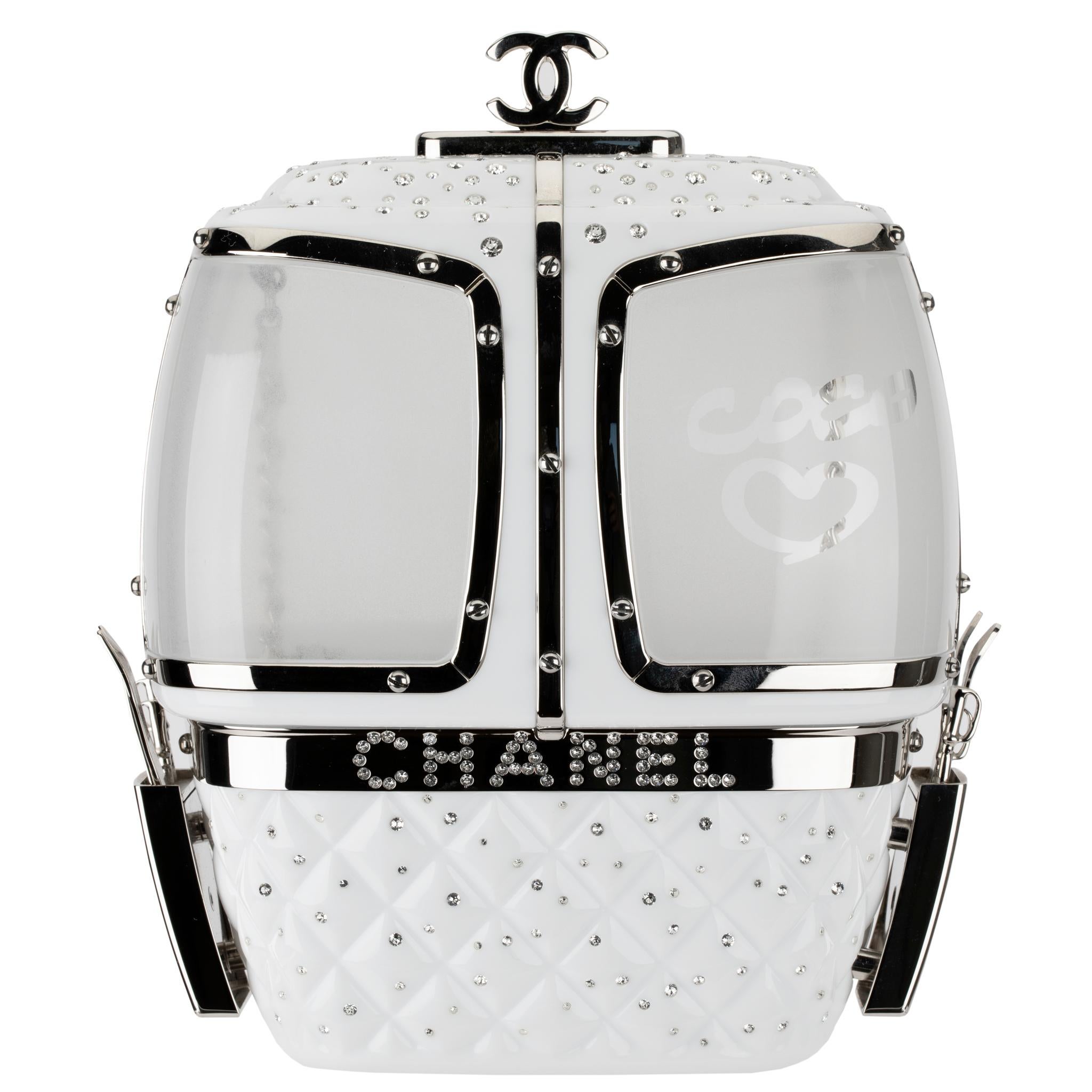 This Ski Gondola Minaudière or, more familiarly known known as a cable cars, from the ski resort themed Fall/Winter 2019 collection is made from snow white lucite, with silver tone hardware and rhinestones decorated throughout. Look closely, and