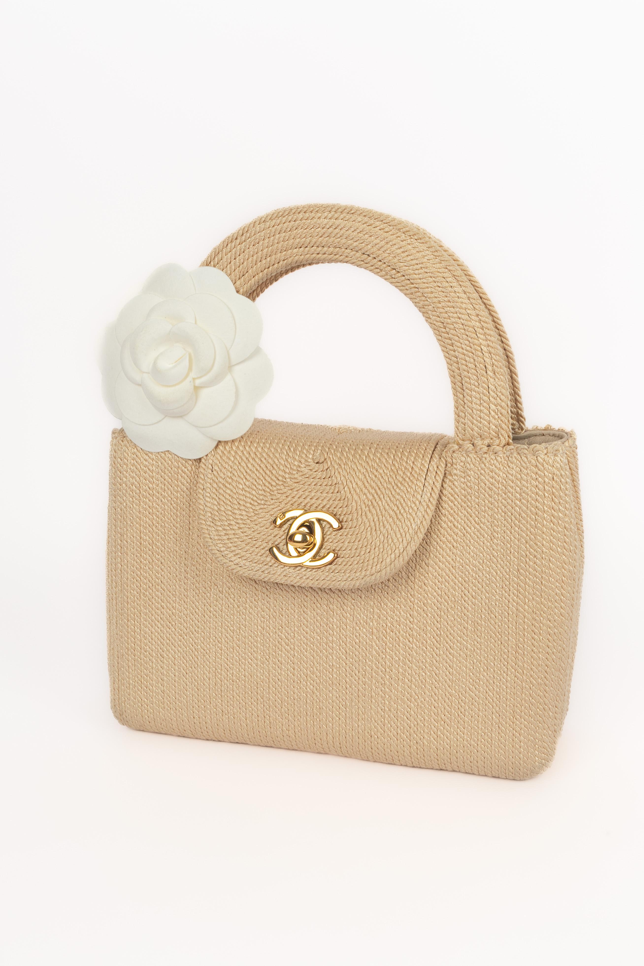 Chanel - (Fabriqué en Italie) Mini sac en cordon de satin tressé doublé d'agneau beige. Éléments métalliques dorés. Pièce accompagnée d'une carte d'authenticité et d'un numéro de série. A Collectional circa 1998 sous la direction artistique de Karl
