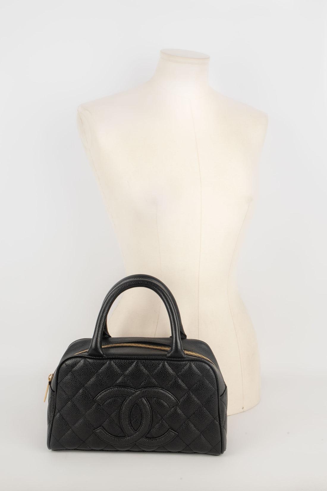Chanel - (Made in France) Black quilted caviar grain calfskin bowling bag. Golden metal elements. A 2005/2006 Collection.

Additional information:
Condition: Very good condition
Dimensions: Length: 26 cm - Height: 15 cm - Depth: 8 cm - Handles: 30