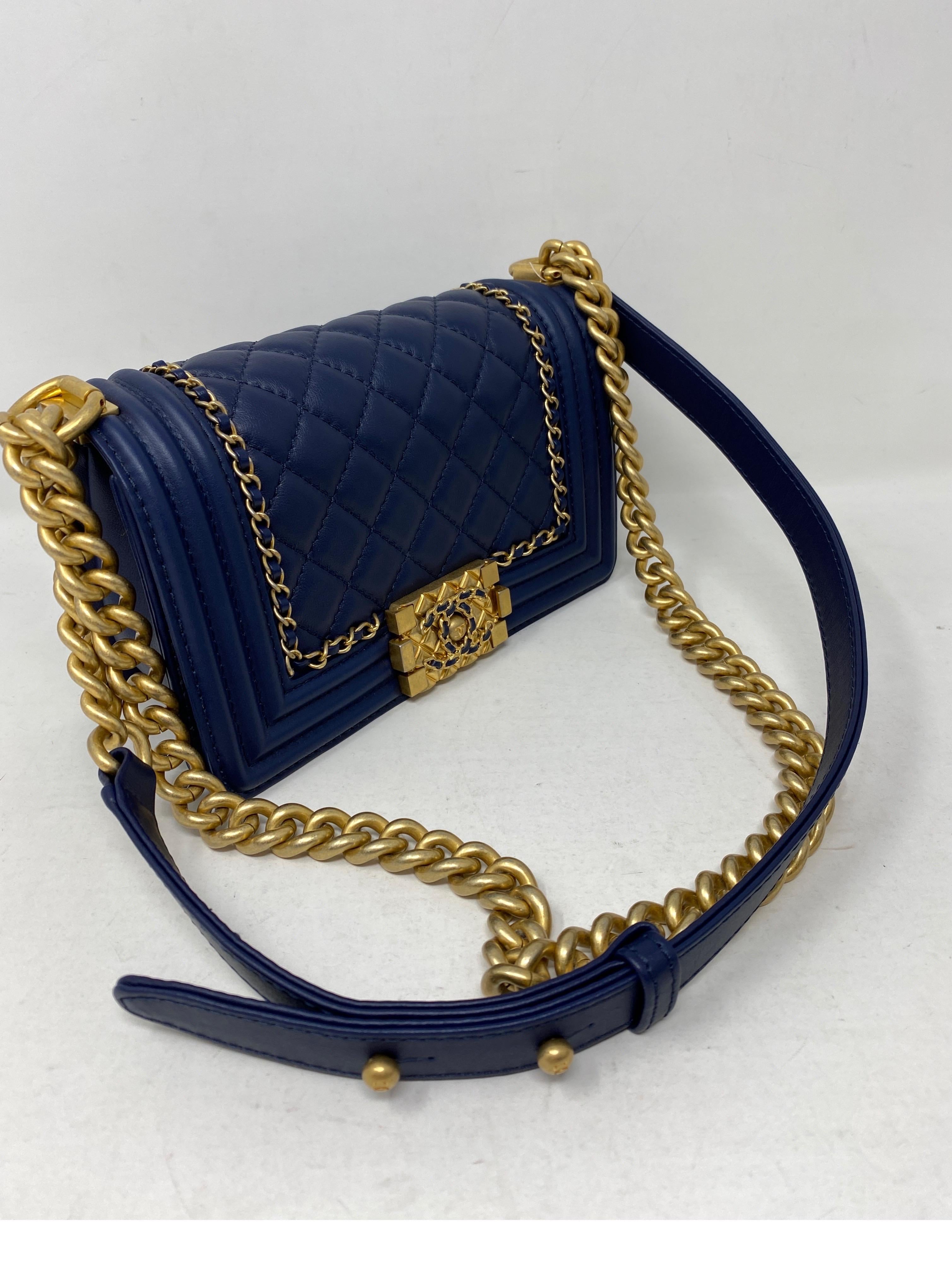 Chanel Navy Limited Edition Mini Boy. Rare gold chain details and unique clasp. Mint condition. Like new. Stunning blue bag. Gold hardware. Includes authenticity card and dust cover. Guaranteed authentic.