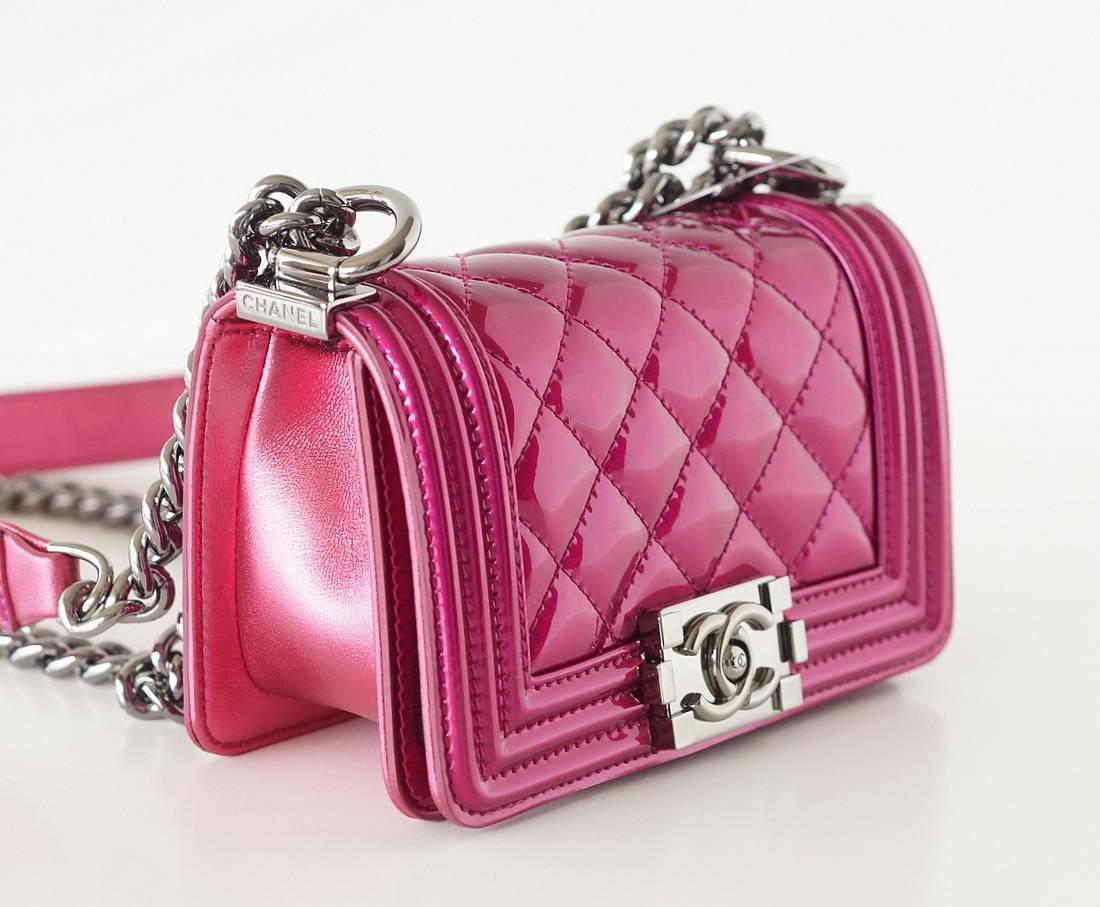 Absolutely fabulous signature Chanel Mini Boy Bag in metallic fuschia patent leather!
Sides and bottom are goatskin.
Ruthenium hardware and CC turnkey.
Signature chain link with padded shoulder strap.   
Signature interior pockets and CHANEL stamp. 