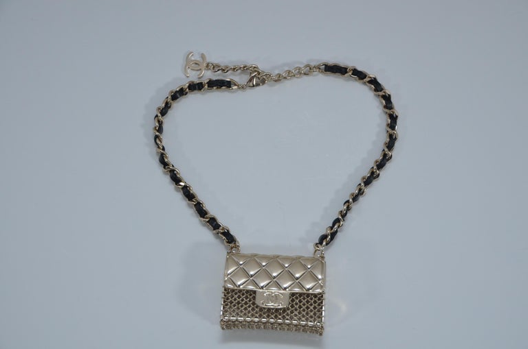 100% AUTHENTIC Chanel mini handbag necklace 
Original receipt with personal info covered will be sent upon request .
Gold tone metal hardware with lambskin woven leather 
Mini purse is kind of functional and can be opened 
New with tags and box
Made