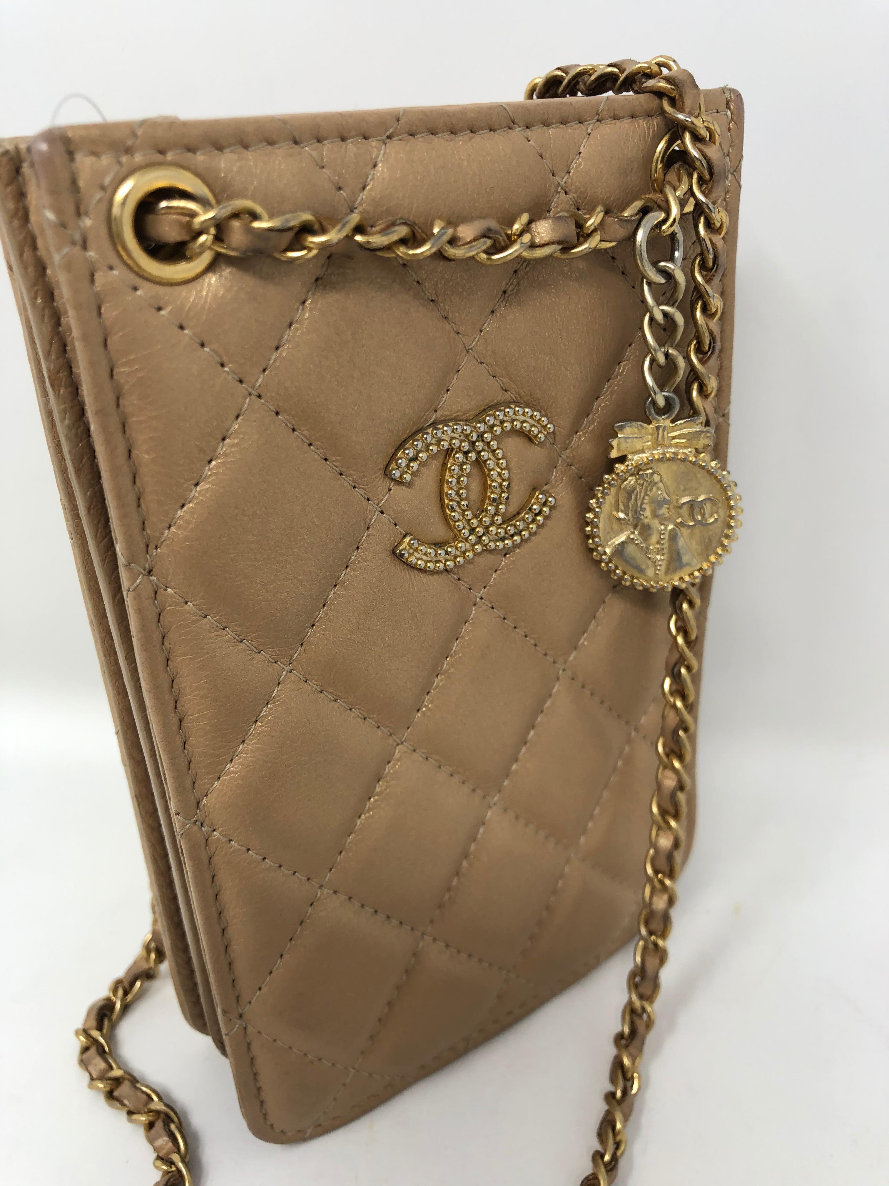 Chanel Mini Tan Camera/ small phone crossbody bag. Goldish tan color with gold hardware. Like new condition. Unique look and style. Rare collector's piece. Guaranteed authentic. 