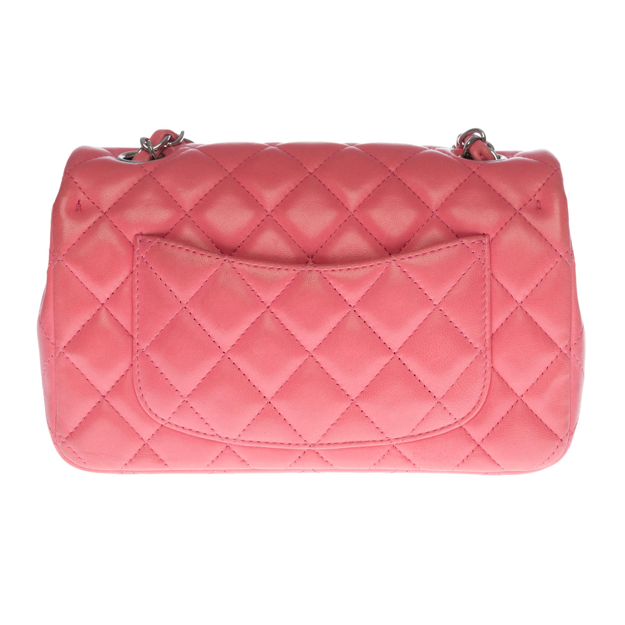 The stunning Chanel Mini Timeless shoulder bag in pink quilted leather, silver metal hardware, silver metal chain handle intertwined with pink leather allowing a shoulder or shoulder strap
Flap closure
A patch pocket on the back of the bag
Lining in