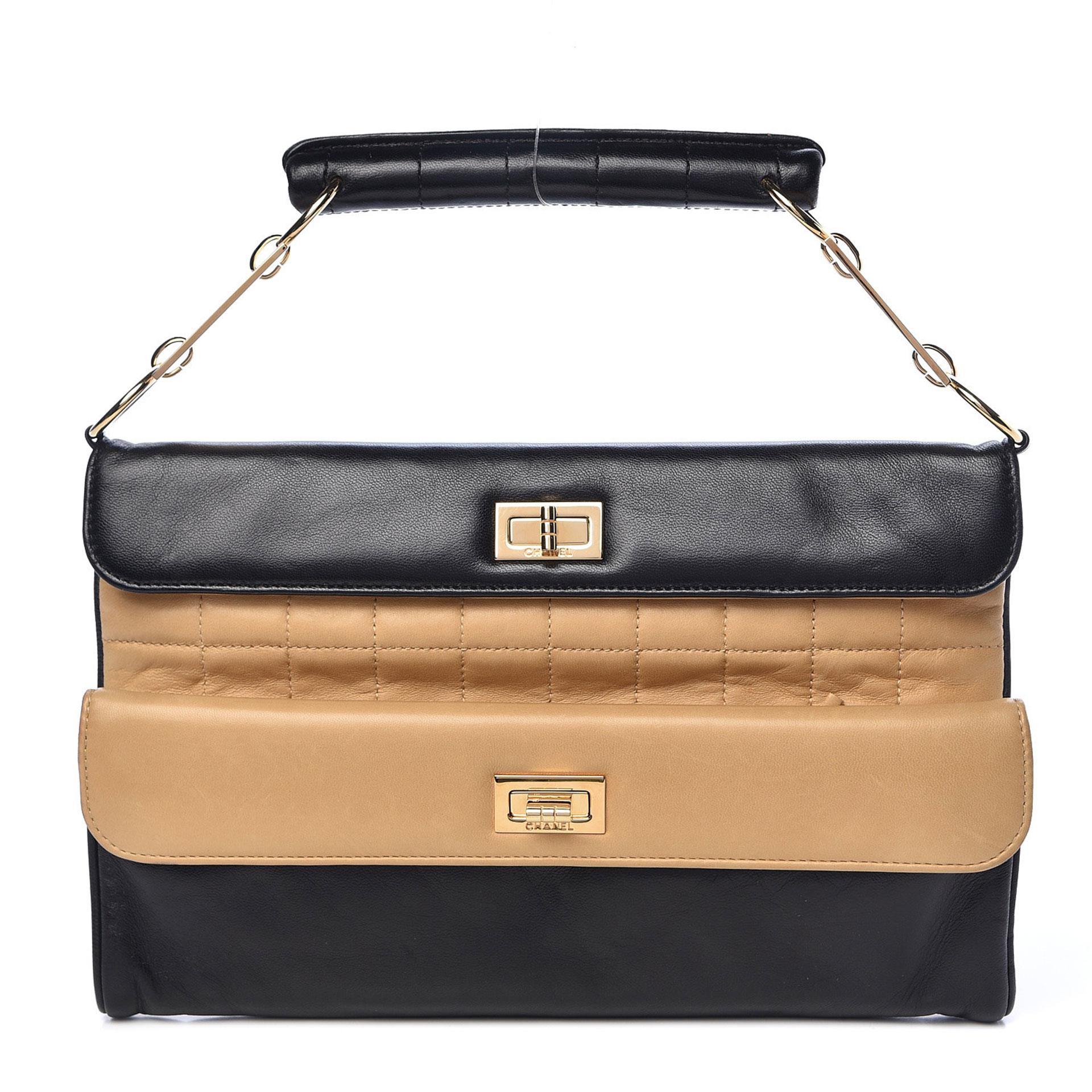 Chanel Mini Two Tone Double Flap Mademoiselle Reissue Satchel 

This stylish clutch is crafted of beige and black lambskin leather. The clutch features a black rolled leather handle with gold hardware and two separate flap openings each with a gold